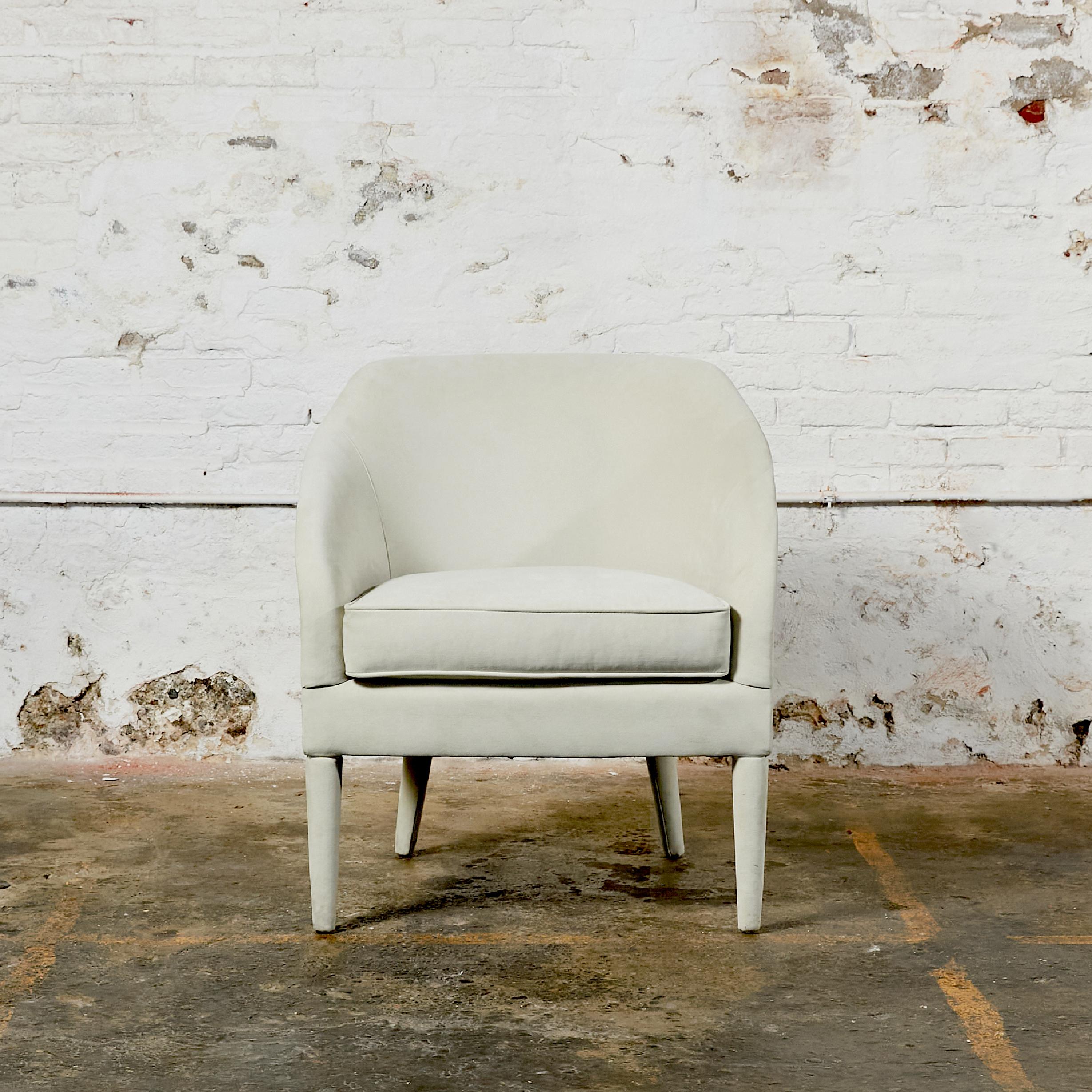 Petite curved back armchair covered in faux suede by Robert Allen.