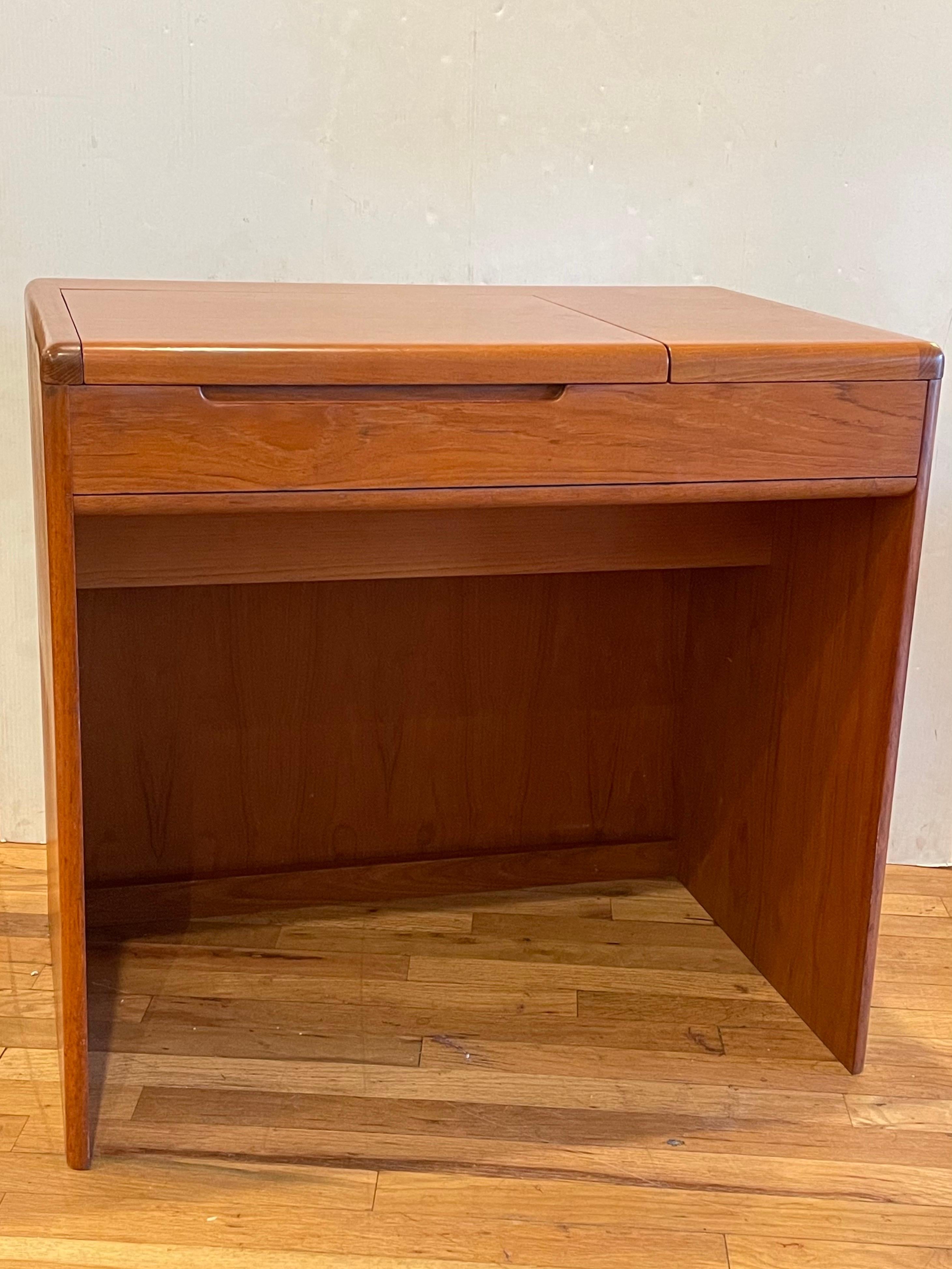 Simple elegant and versatile small desk/vanity, circa 1980s in original teak finish and condition very clean, with mirror and removable box drawer.
