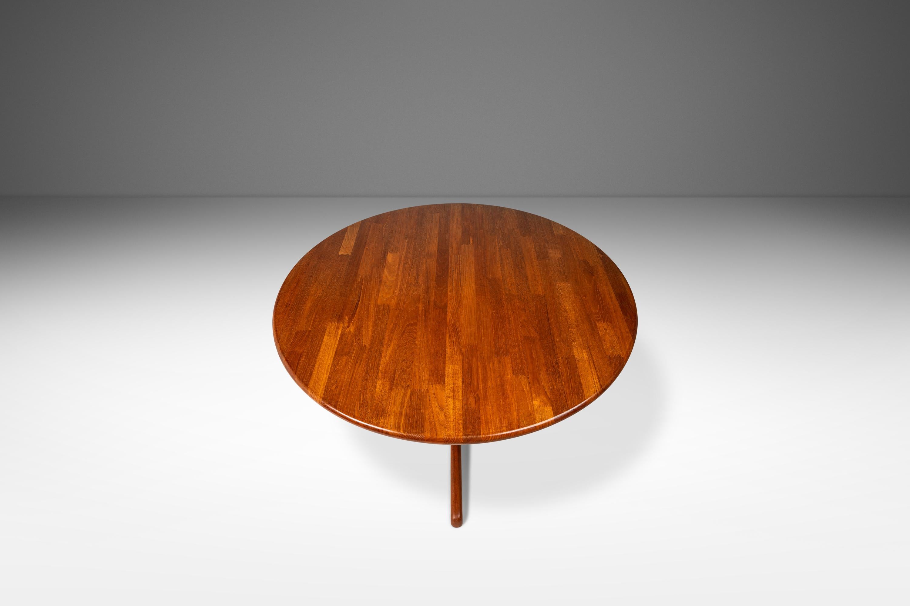 Introducing a stunning Danish-made dining table designed by Tarm Stole for OG Møbelfabrik. In remarkable 100% original, vintage condition this petite table is constructed from solid slabs of Burmese teak with exceptional woodgrains throughout.