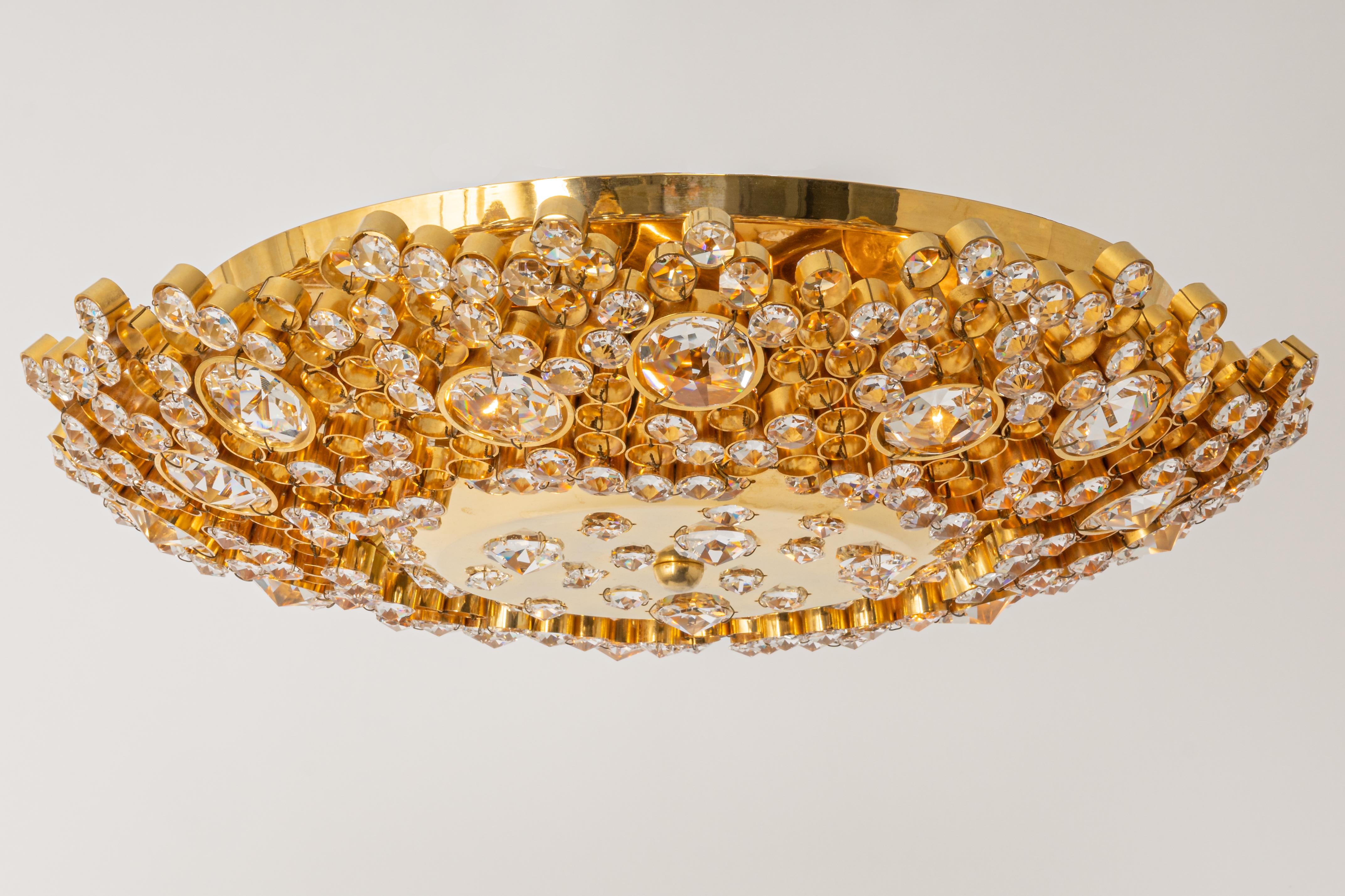 Delicate floral Flush mount light with crystal glass and gilded brass parts made by Palwa, Germany, 1970s. Featuring a multitude of crystal glasses.

Sockets: 5 small bulbs (E-14) max each 40W.
Light bulbs are not included. It is possible to