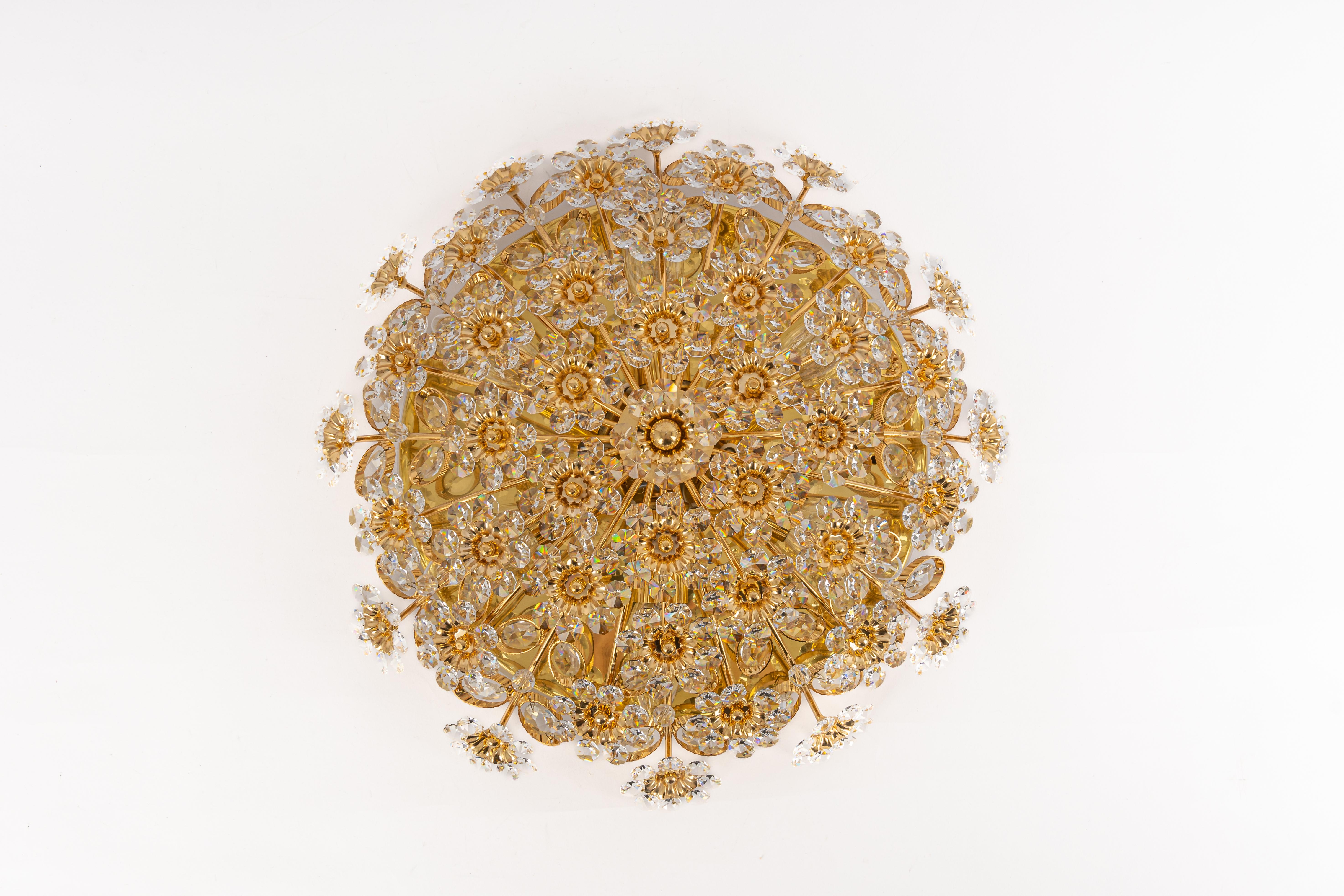 Petite Delicate floral Flush mount with crystal glass and gilded brass parts made by Palwa, Germany, 1970s. Featuring a multitude of crystal glass flowers.
Measures: Diameter 16