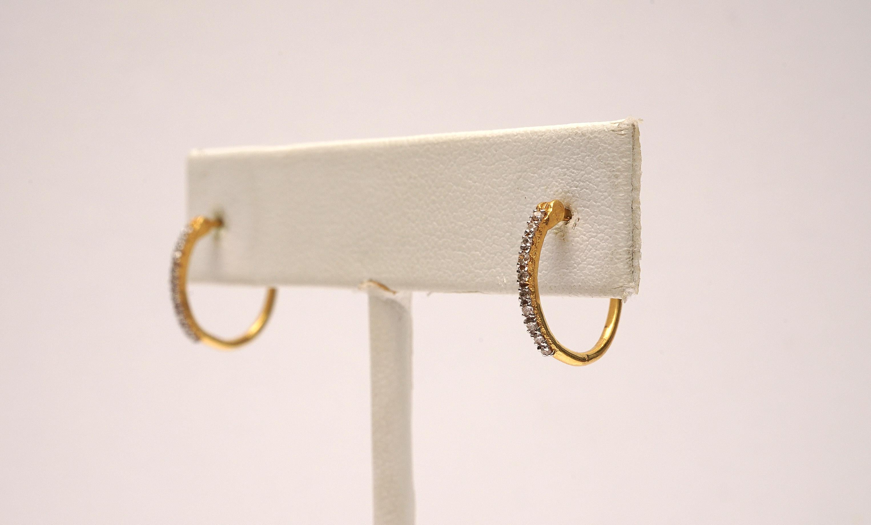 A sweet size diamond hoop with diamonds all along the front half of the earrings.  Snap closure.  Easy and versatile.  18K gold.
