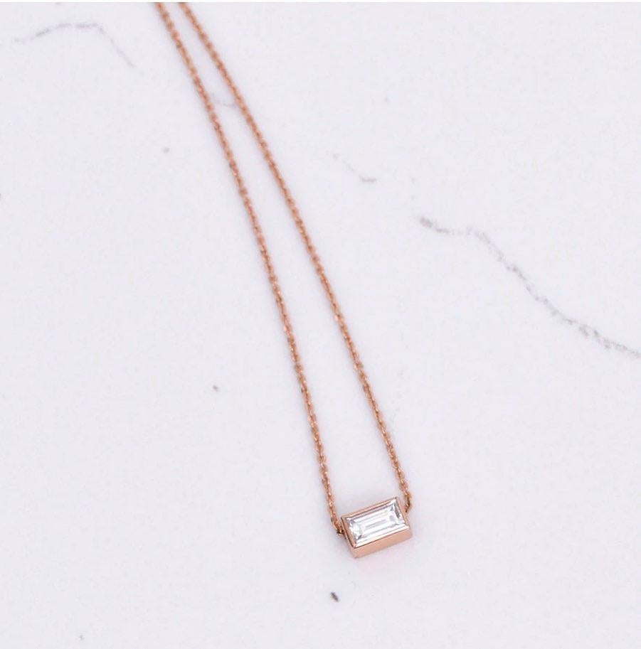 A simply stunning .40 carat diamond baguette pendant in 14k rose gold. Dimensions are 6.6mm x 3.9mm