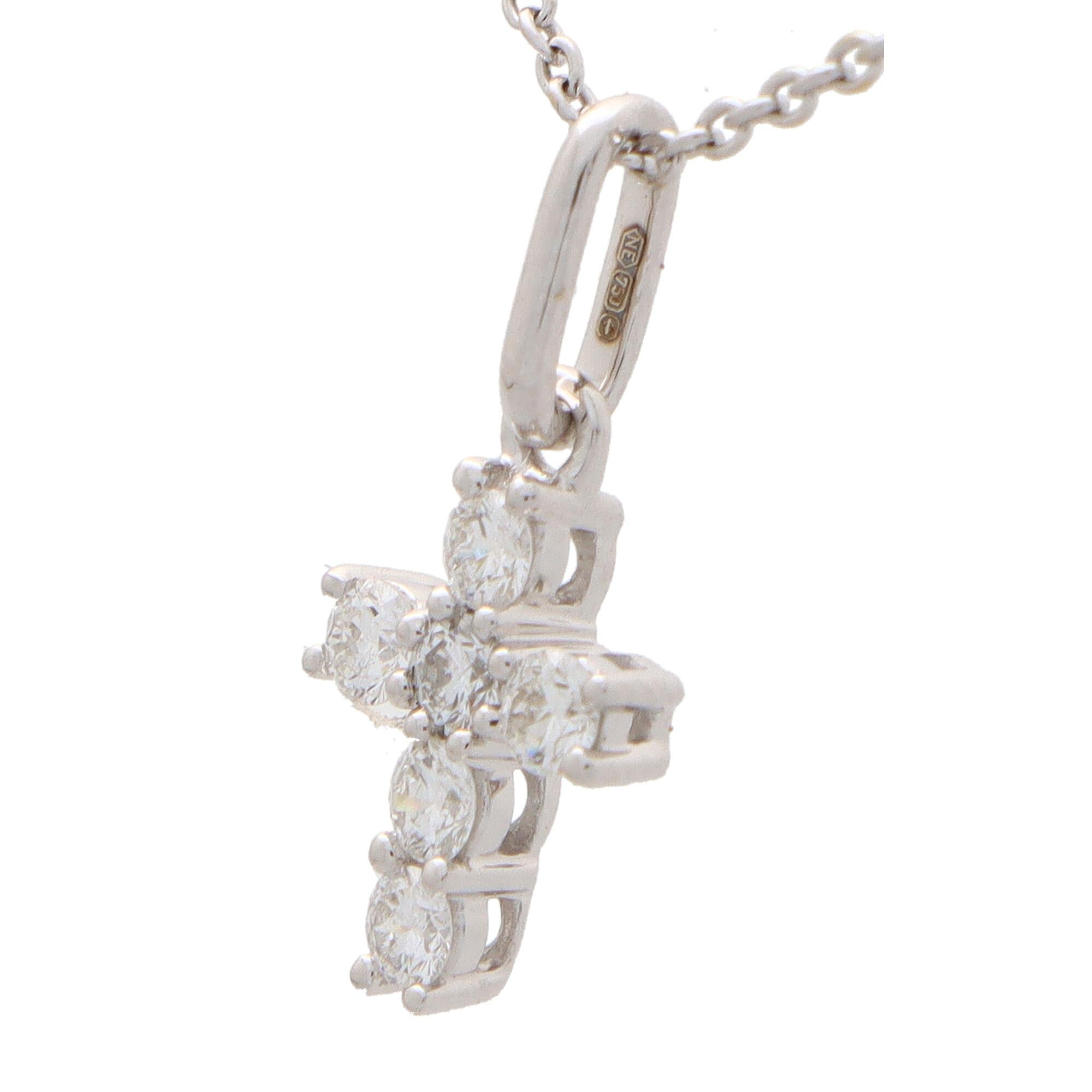A lovely diamond cross pendant set in 18k white gold.

The cross itself is beautifully crafted and is composed of 6 individual claw set round brilliant cut diamonds. The cross hangs from a polish white gold bail allowing the pendant to be added to a