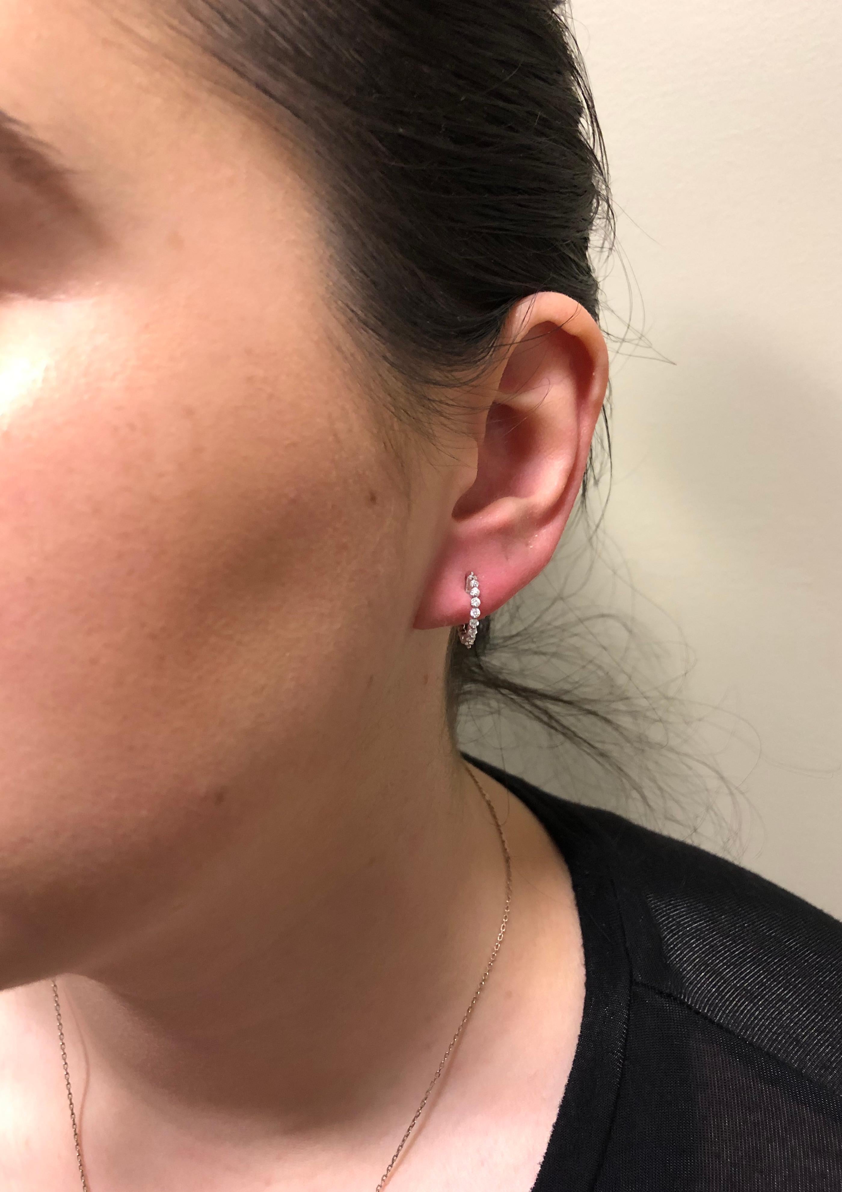 These 14K white gold hoop earrings feature approximately .25CTW of beautiful Round Brilliant Cut Diamonds.

Diamond Carat Weight: Approximately .25CTW 
Diamond Cut:  18 Round Brilliant
Color: Average G-J
Clarity: Average SI-I
Metal: 14K White