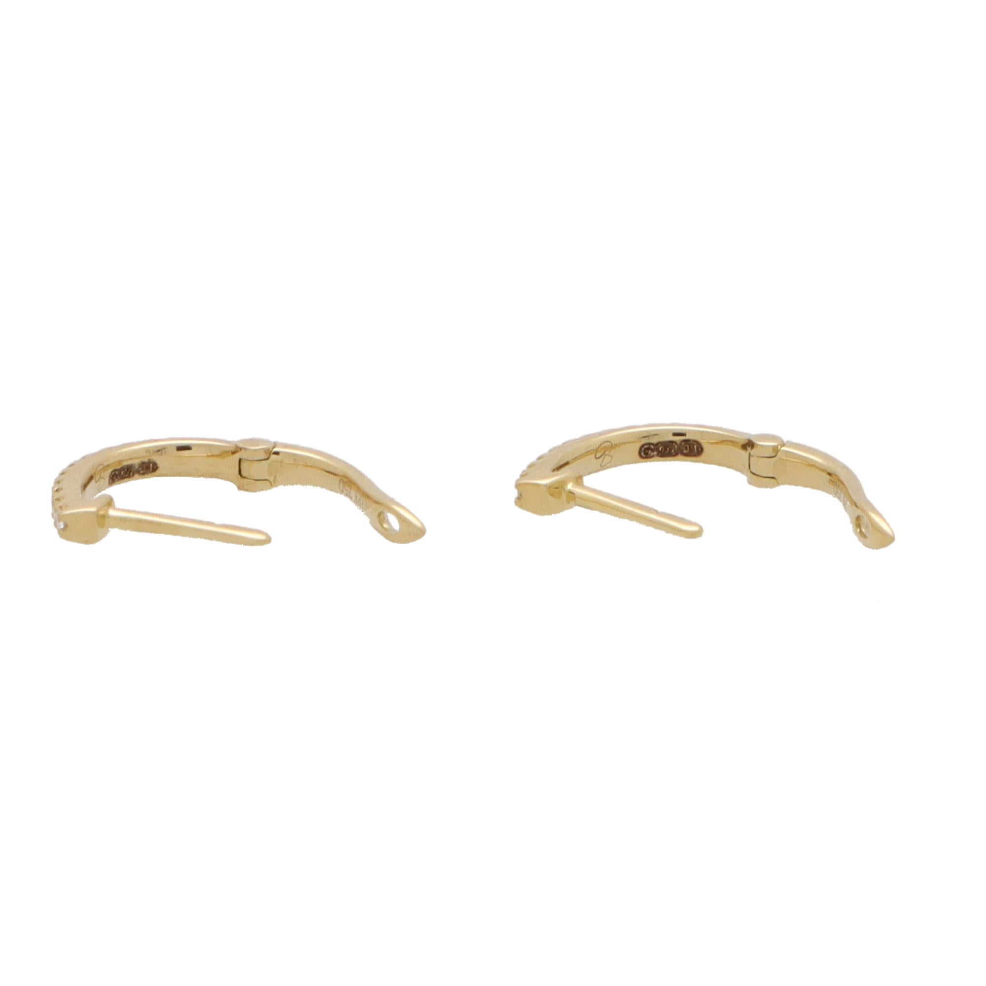  A perfect everyday pair of diamond hoop earrings set in 18k yellow gold.

The earrings are pave set to the front with round brilliant cut diamonds and secured with a post and hinge shut fitting.

Due to the design and size these earrings would make