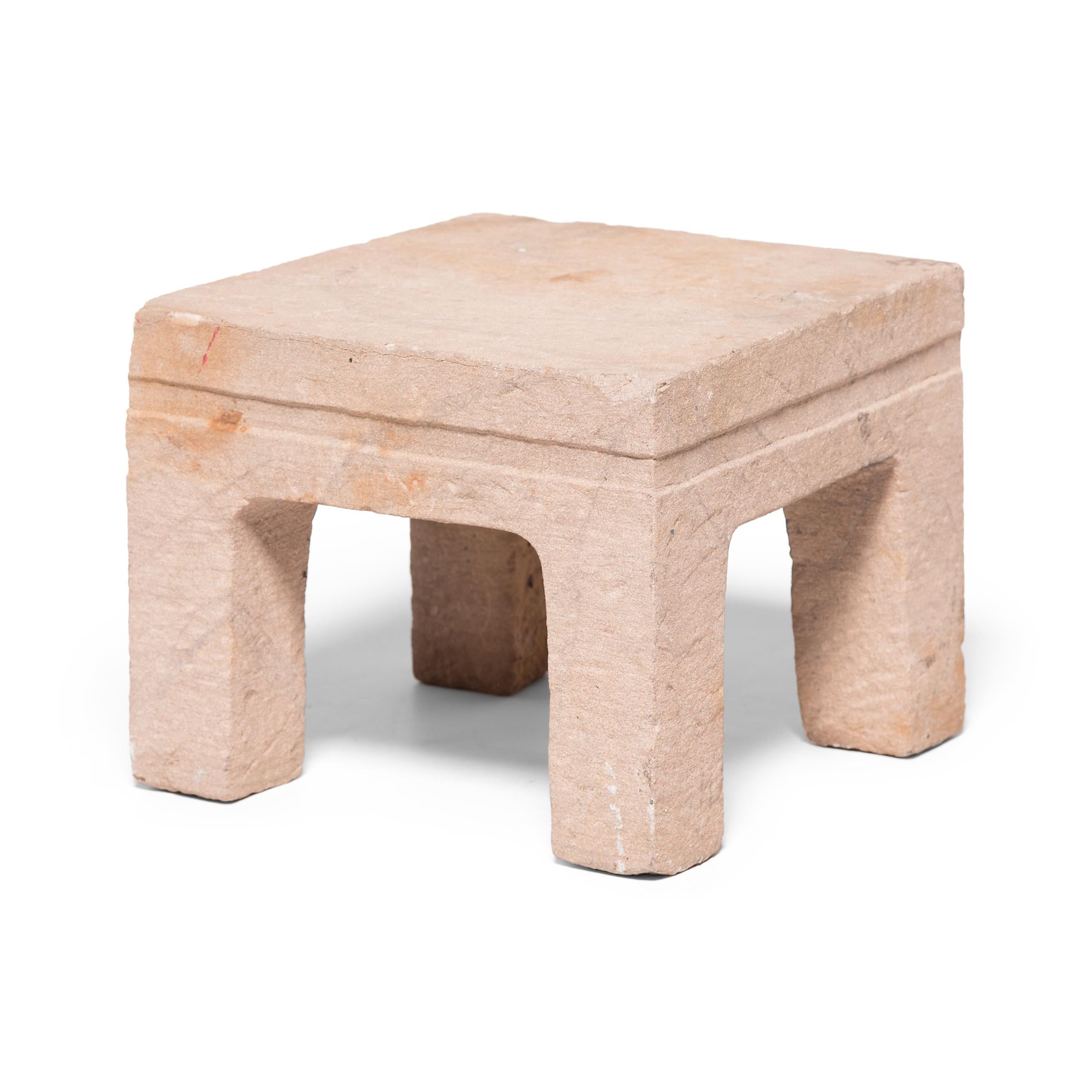 This fang deng, which translates literally to square stool, was hand carved from a solid piece of limestone nearly 250 years ago in northern China. Centuries of use have lent the stone a beautifully worn patina, accentuated by the irregular texture