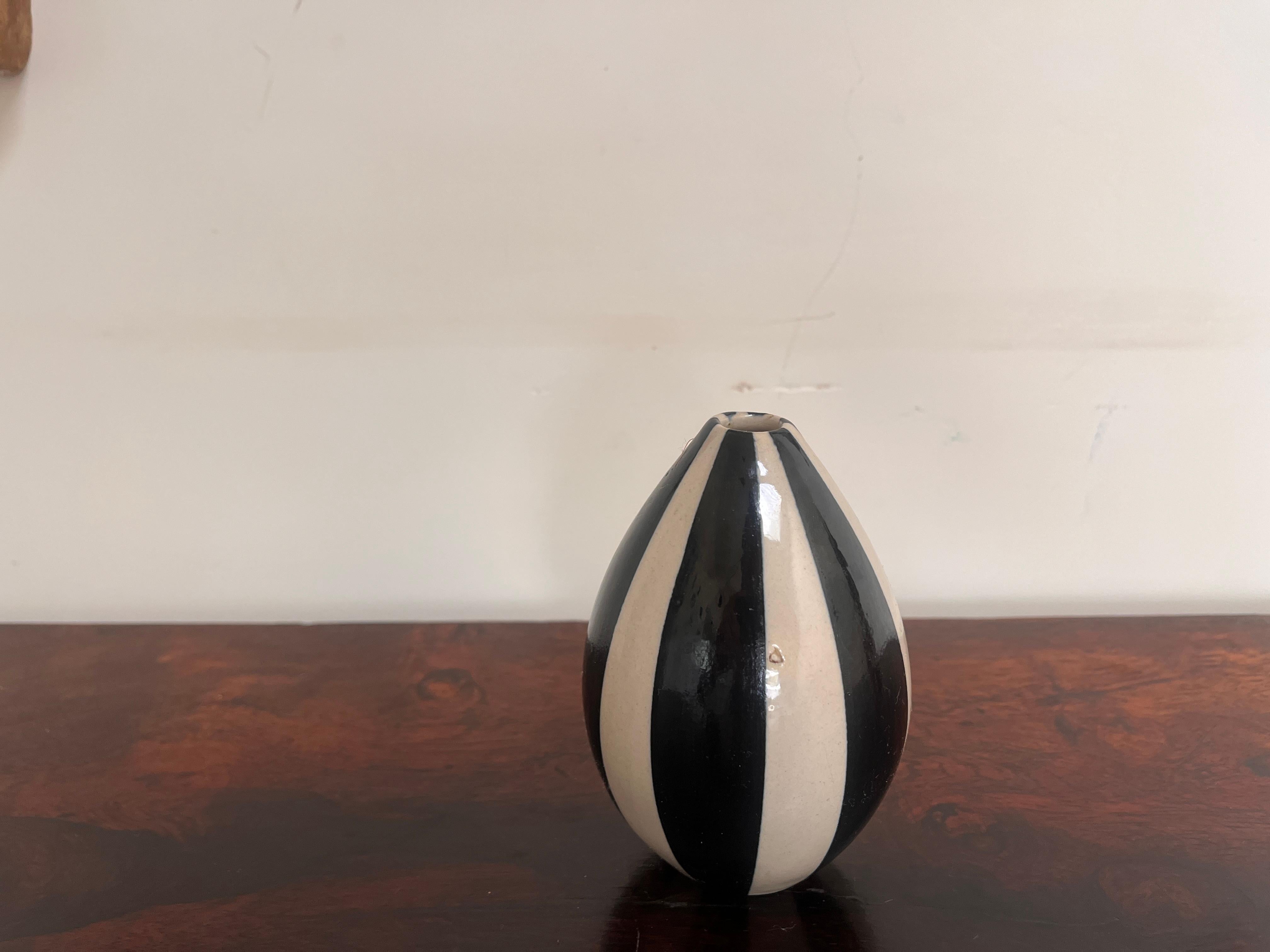 Petite bud vase or diffuser in black and white vertical stripes. Early 1990's Jonathan Adler. Artisan-made piece, logo stamped on the bottom.