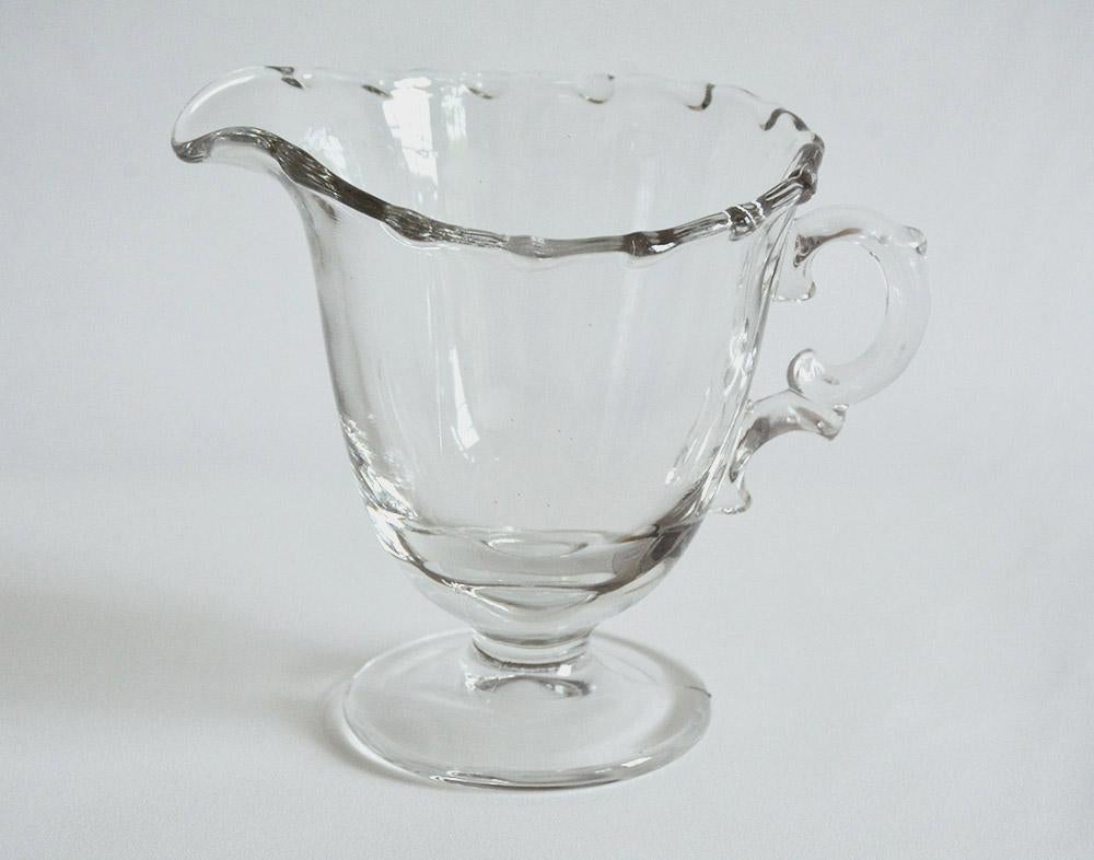Elegant clear leaded glass milk or cream pitcher on pedestal base. Wonderful to pair with other serving pieces for tea or coffee. Can be used for serving syrup, gravy or other liquid condiments.
OFFERING FREE SHIPPING ON THIS ITEM -- US