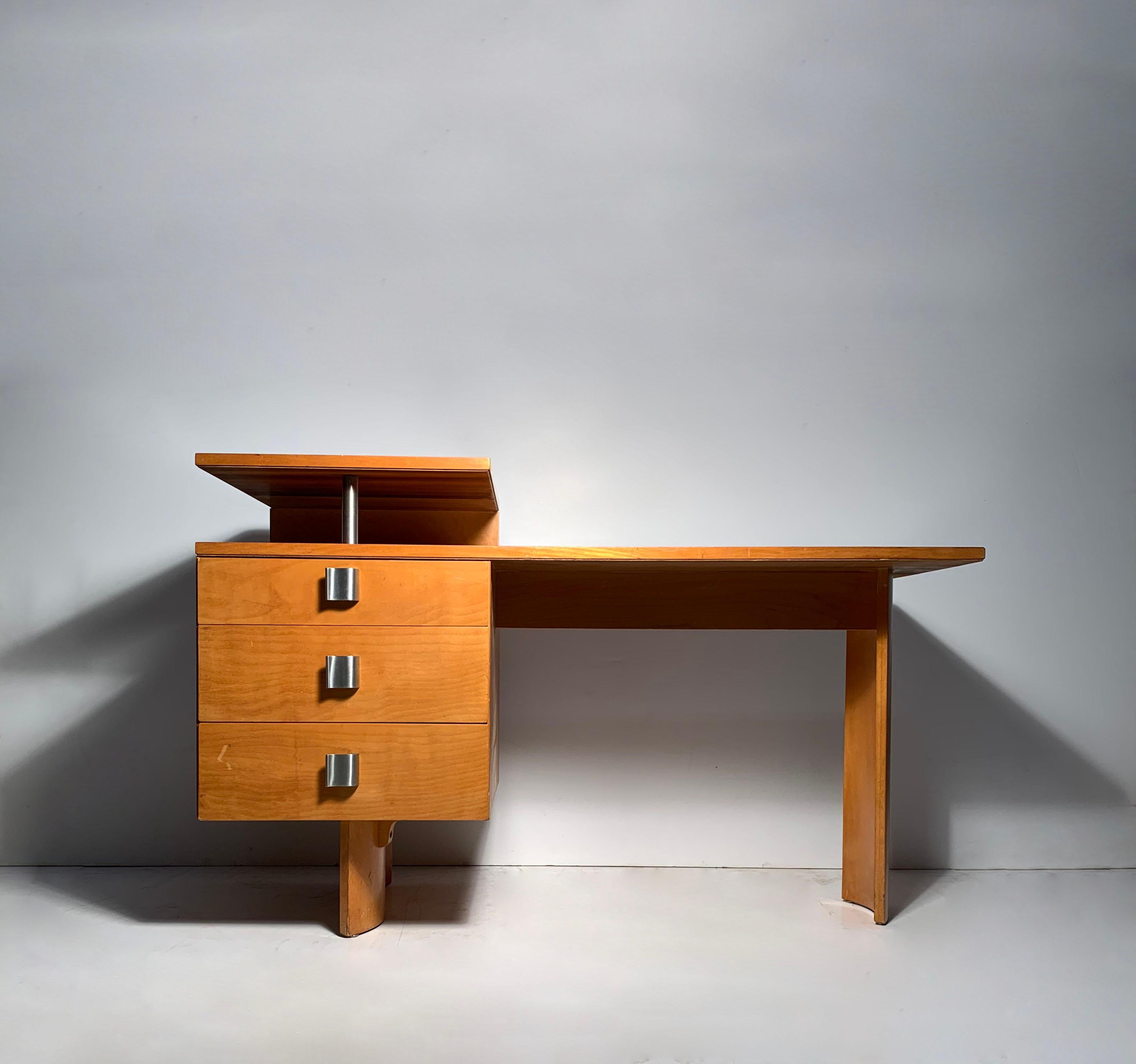 A petite scale Eliel Saarinen Deco Desk in Birch with Wave-like Aluminum Pulls.

Dimensions:

48 wide
20 depth
Height to top shelf: 30 1/16