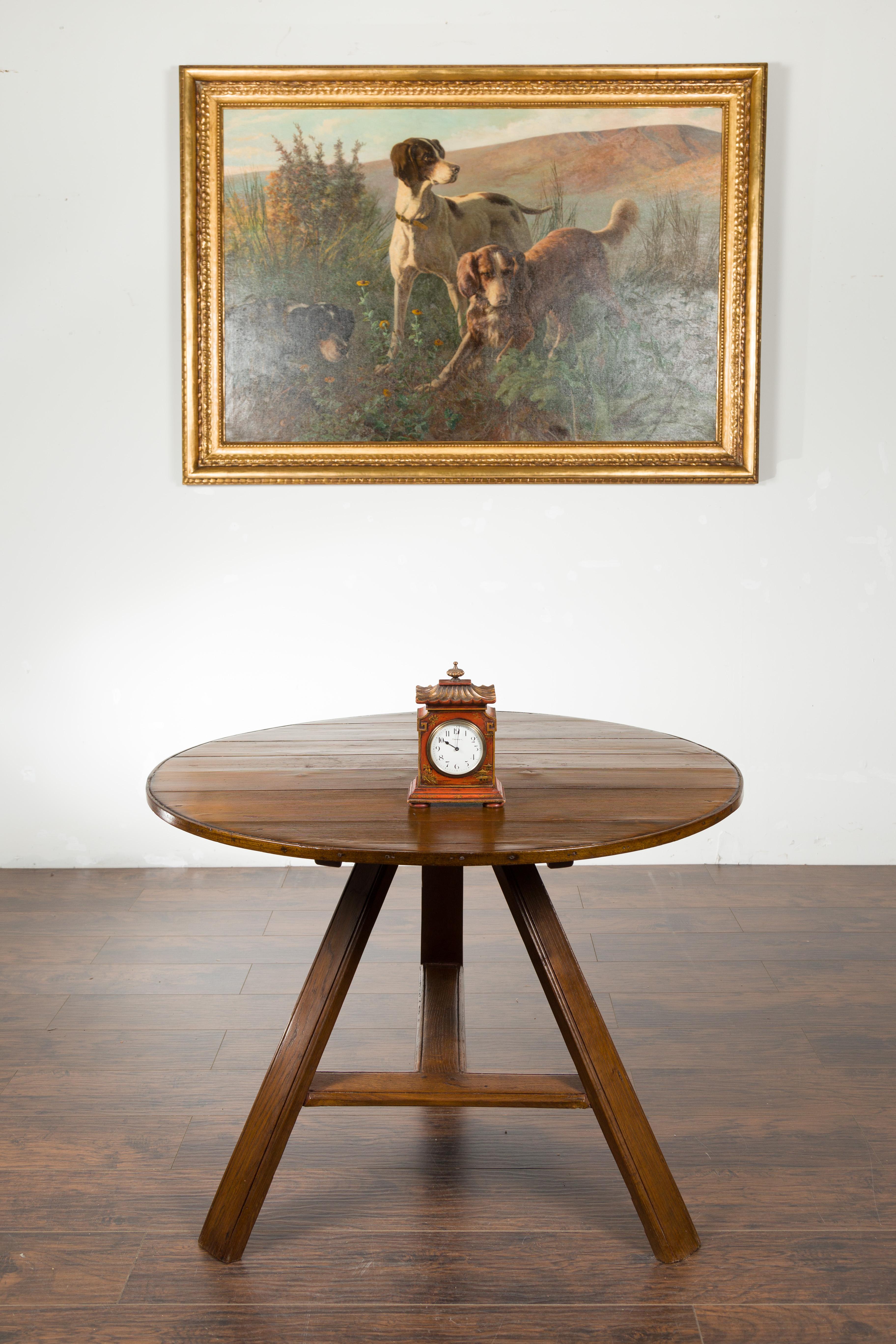 An English Asprey London painted wood mantel clock from the mid 20th century, with gilt Chinoiserie motifs and pagoda roof. Created in England during the second quarter of the 20th century, this Asprey painted clock captures our attention with its