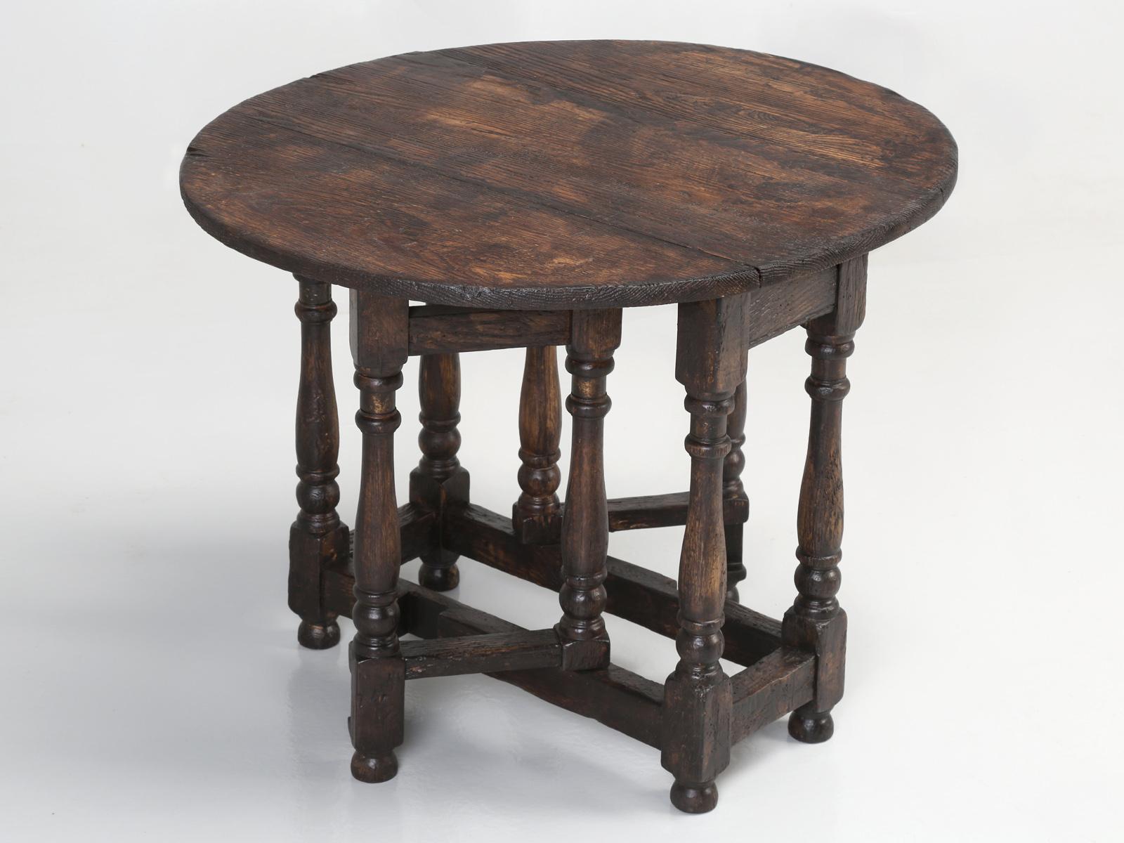Petite old drop-leaf side table or even can be used as a coffee table, made from solid white oak and could be English or even French, since it was discovered in the South of France. Very nice old world patina and our very small drop-leaf end table,