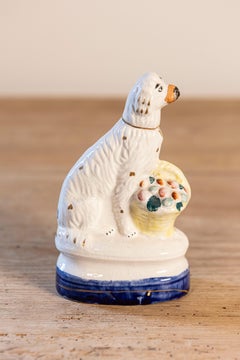 Petite English Michael Davis Porcelain Dog with Fruit Basket and Blue Oval Base