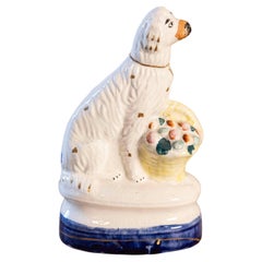 Petite English Michael Davis Porcelain Dog with Fruit Basket and Blue Oval Base