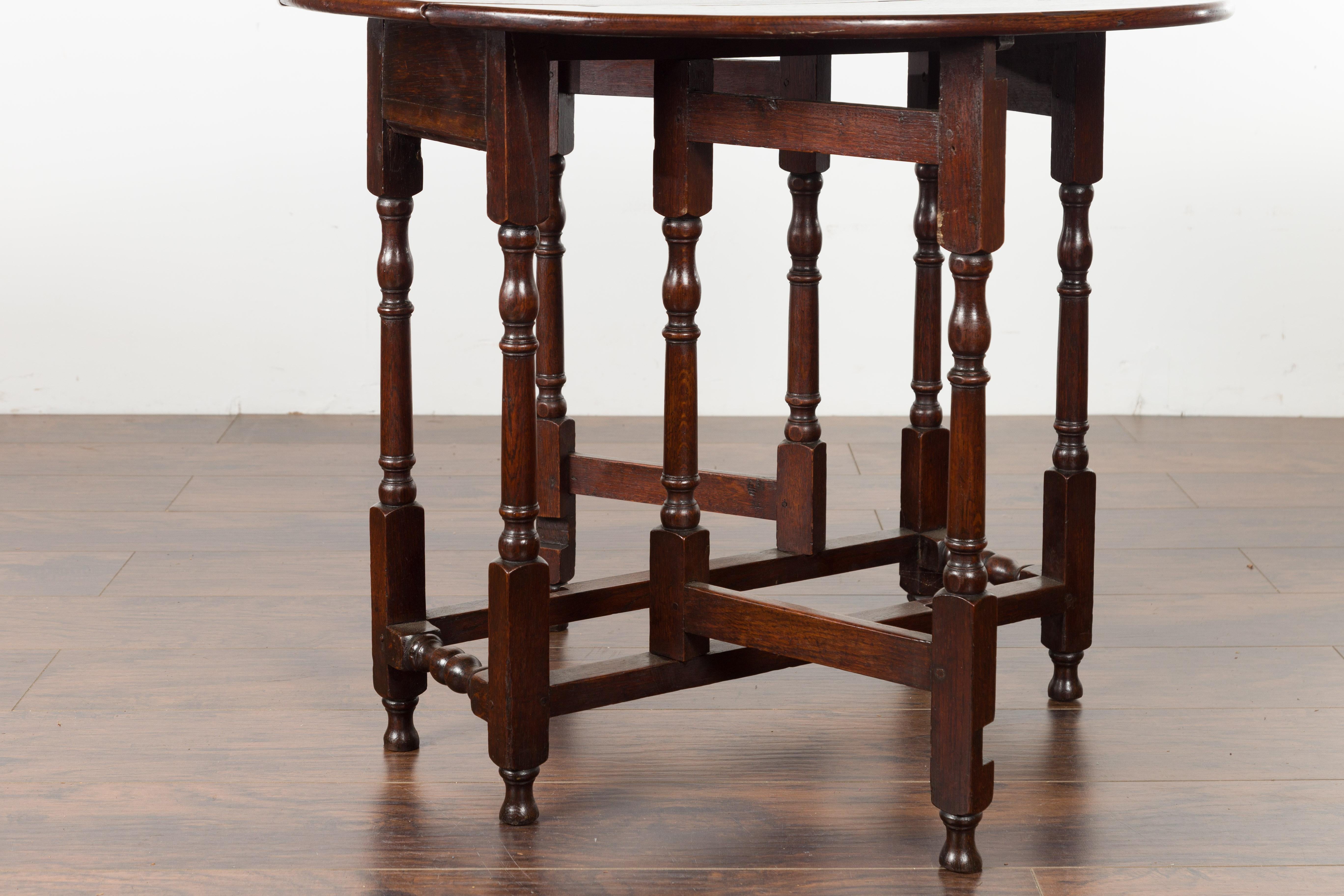 Petite English Oval Oak 19th Century Drop-Leaf Table with Baluster Legs For Sale 6