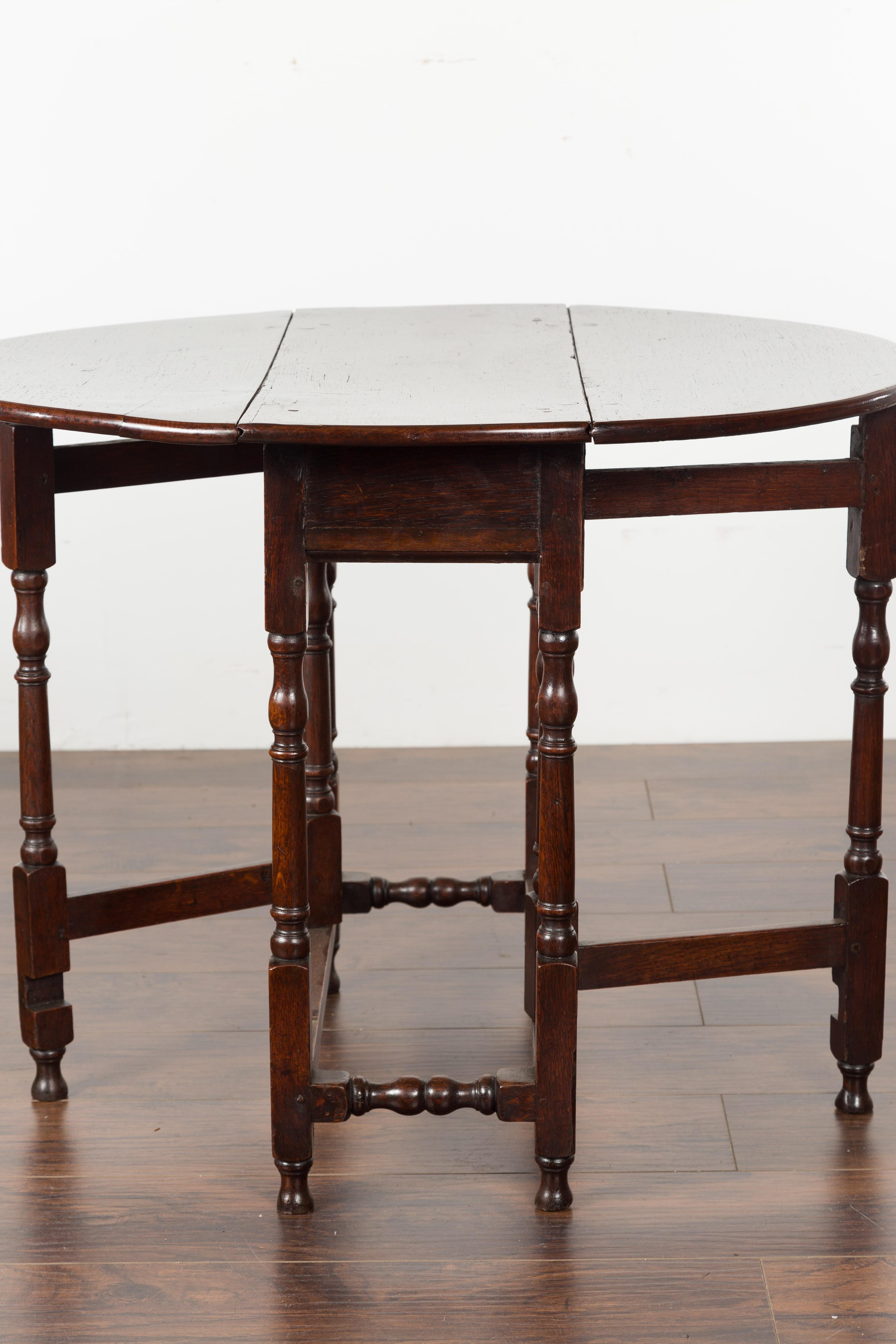 Petite English Oval Oak 19th Century Drop-Leaf Table with Baluster Legs For Sale 8