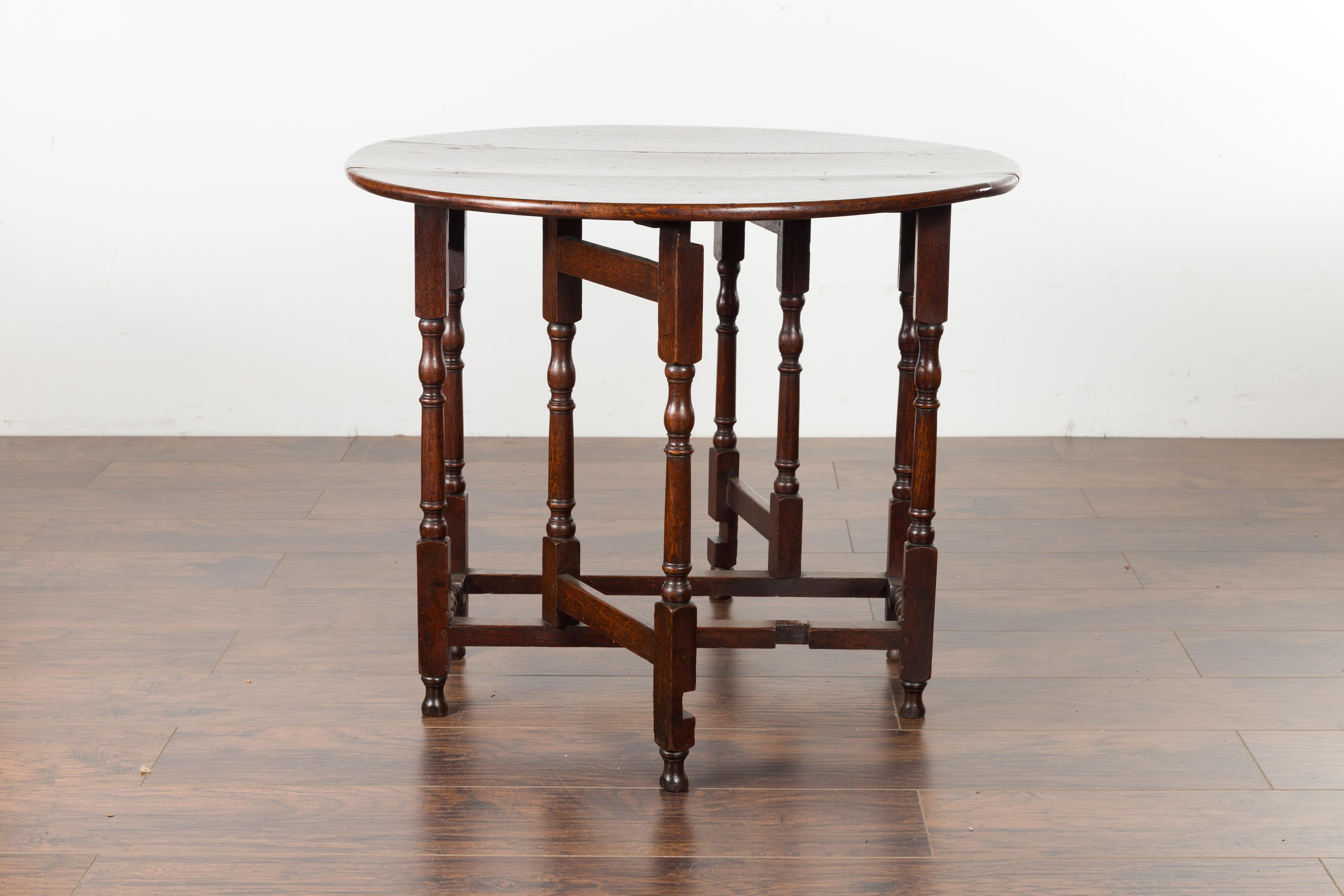 Petite English Oval Oak 19th Century Drop-Leaf Table with Baluster Legs For Sale 9