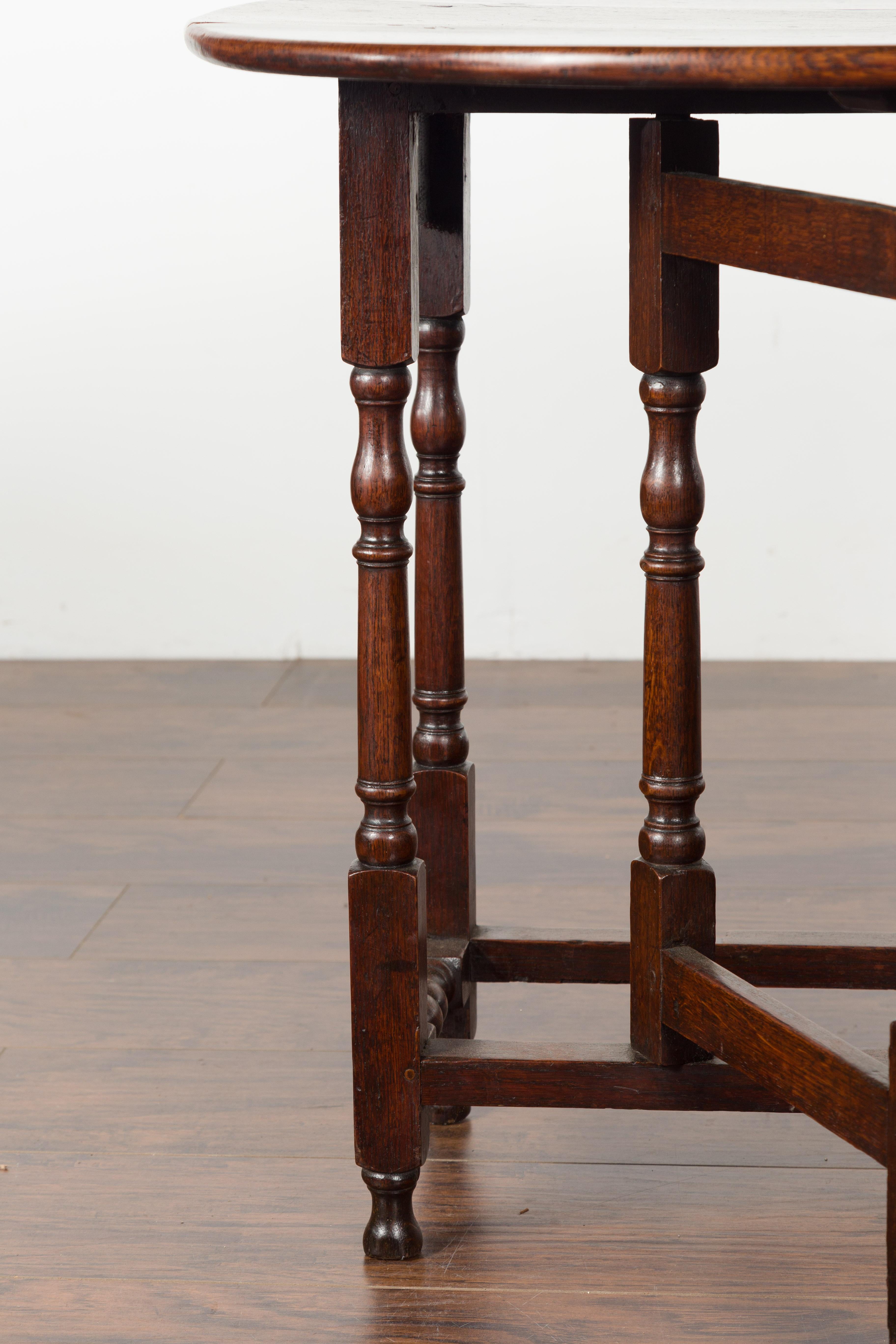Petite English Oval Oak 19th Century Drop-Leaf Table with Baluster Legs For Sale 10