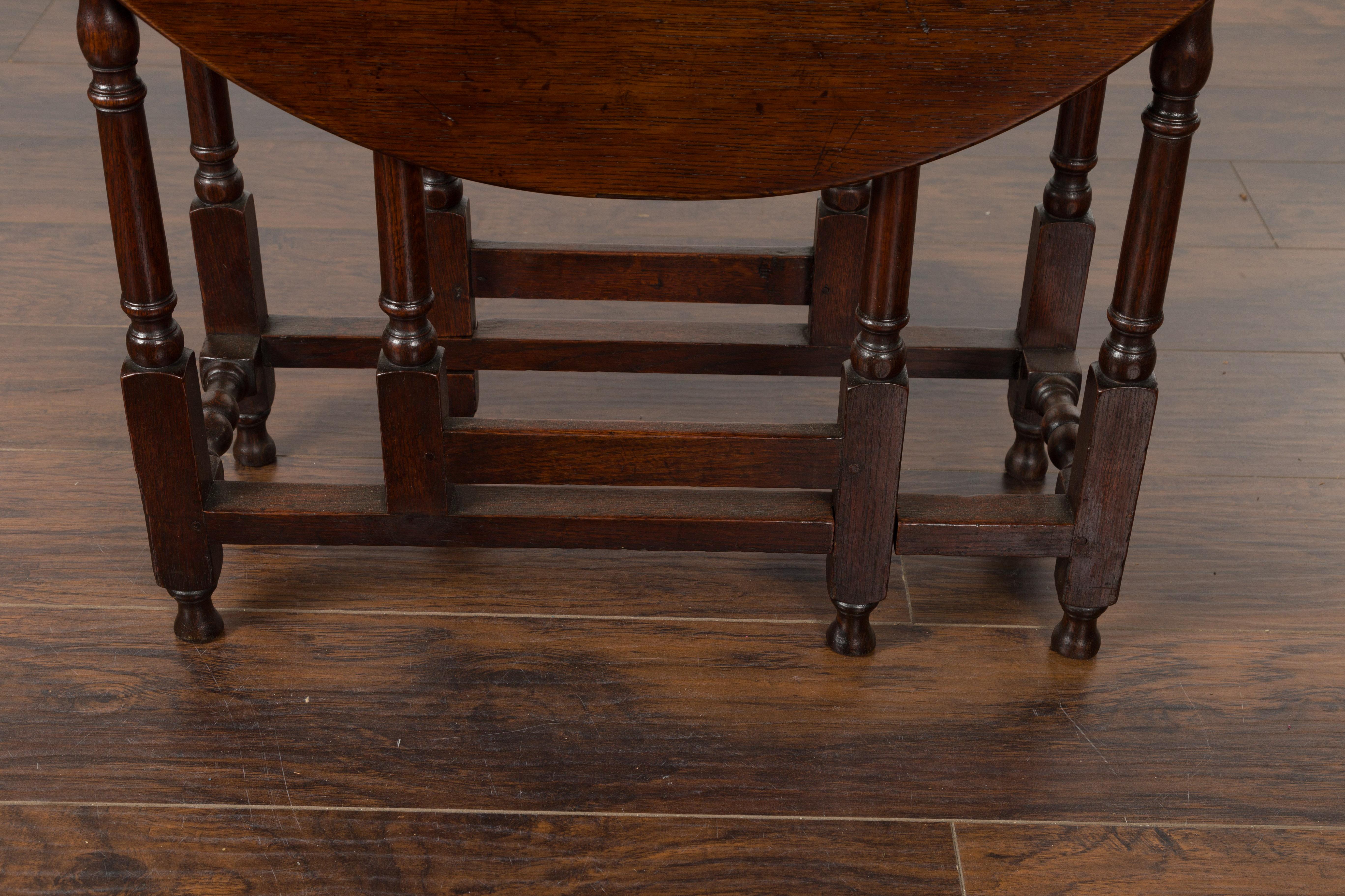 Petite English Oval Oak 19th Century Drop-Leaf Table with Baluster Legs In Good Condition For Sale In Atlanta, GA