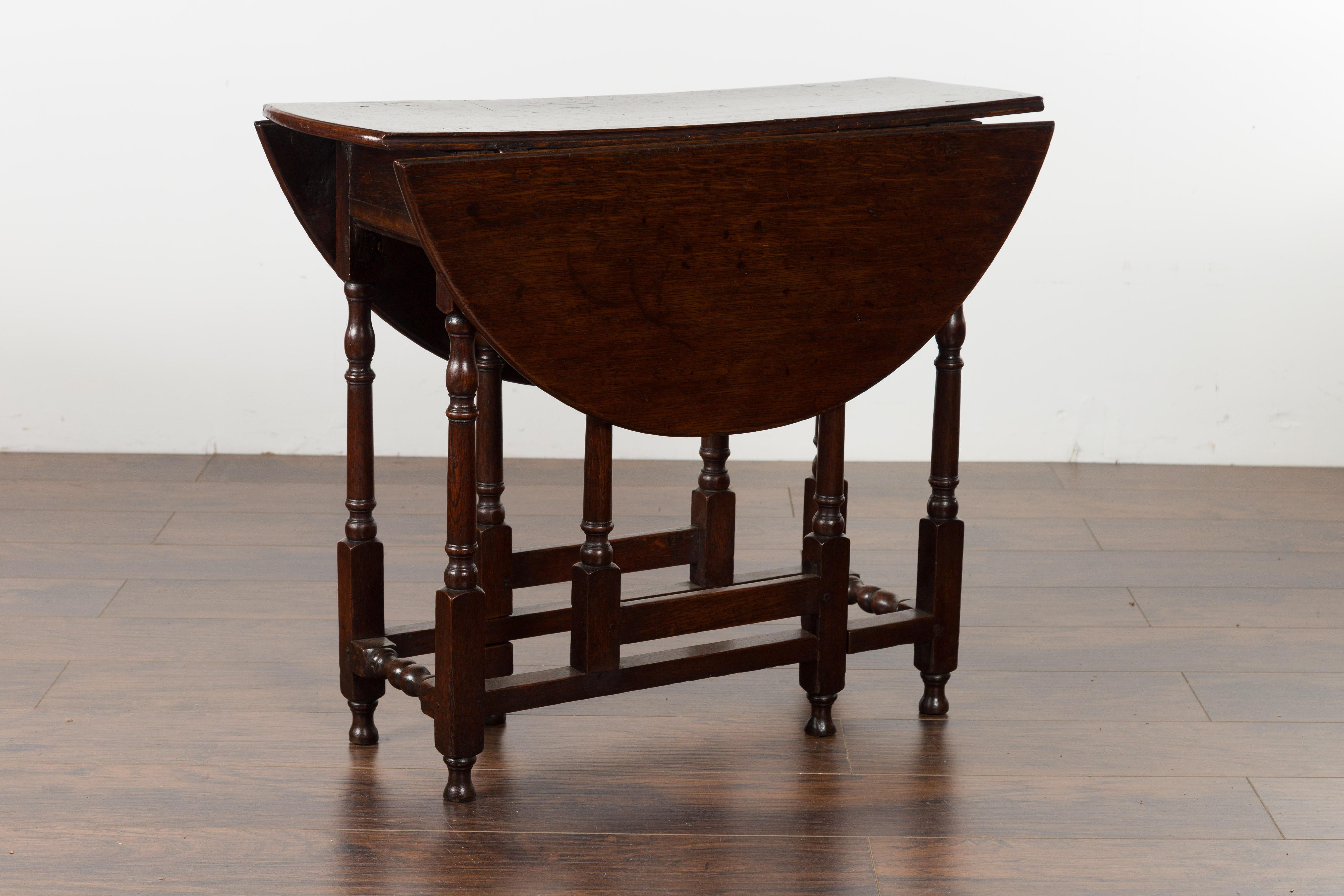 Petite English Oval Oak 19th Century Drop-Leaf Table with Baluster Legs For Sale 1