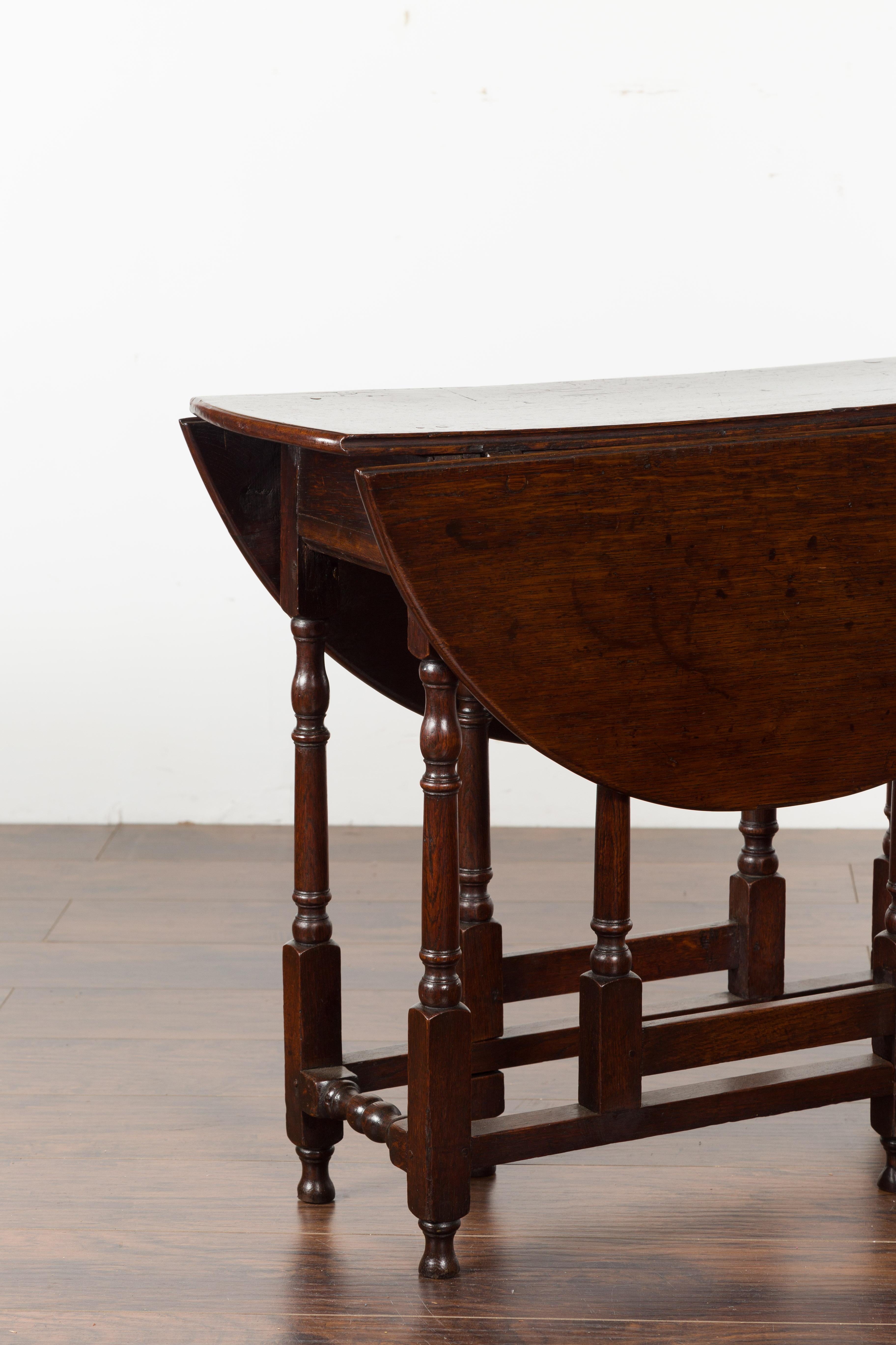 Petite English Oval Oak 19th Century Drop-Leaf Table with Baluster Legs For Sale 3
