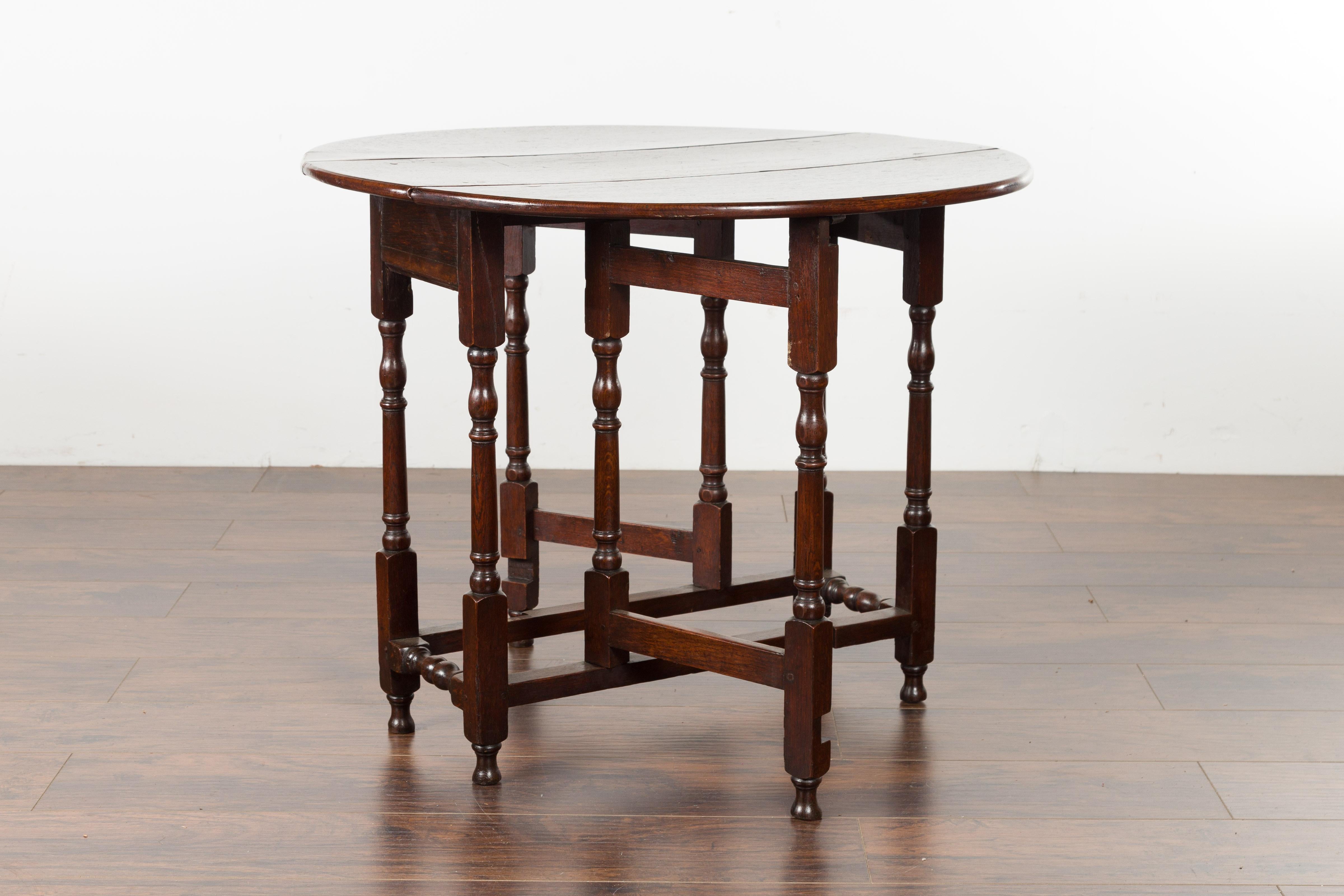 Petite English Oval Oak 19th Century Drop-Leaf Table with Baluster Legs For Sale 4