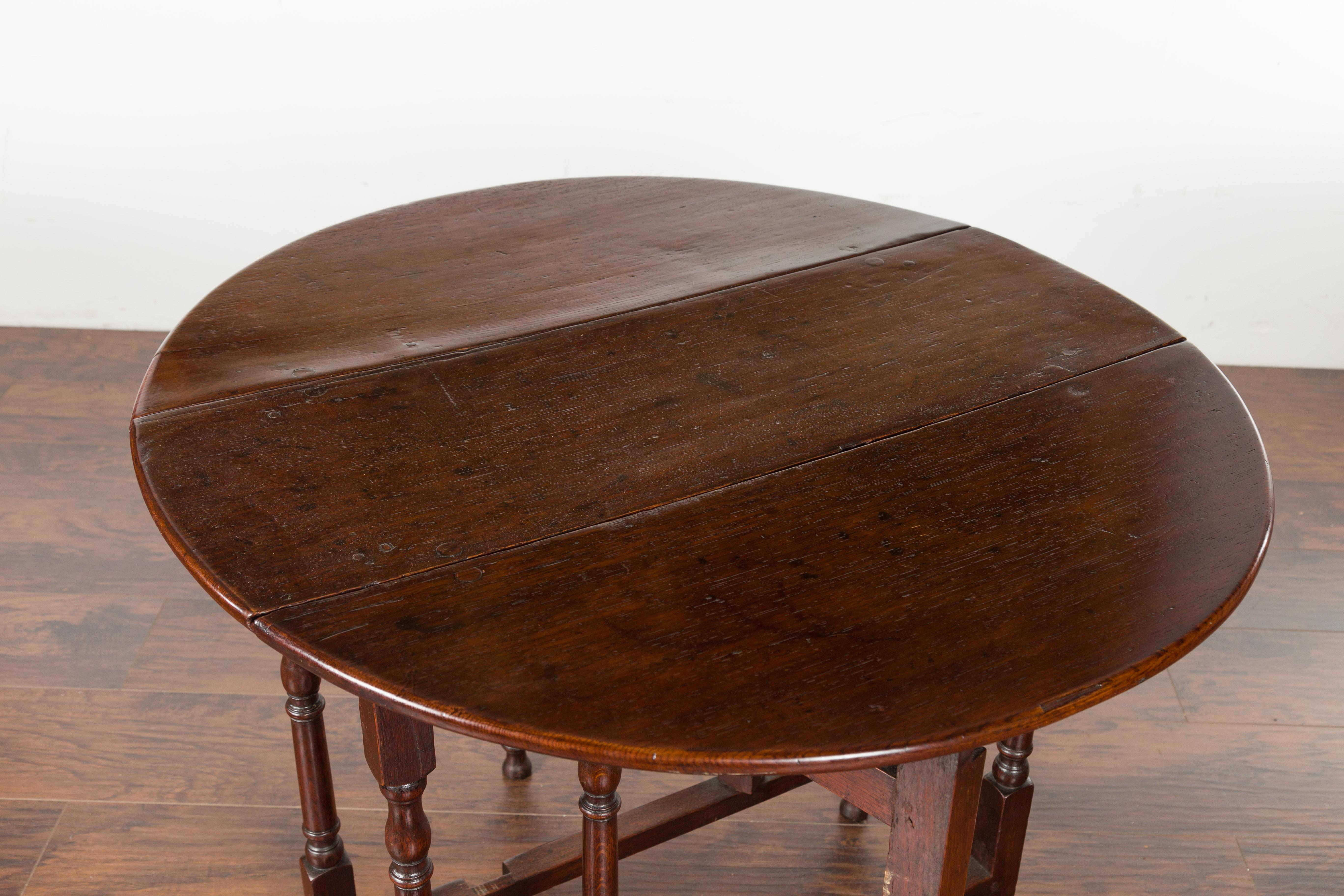 Petite English Oval Oak 19th Century Drop-Leaf Table with Baluster Legs For Sale 5
