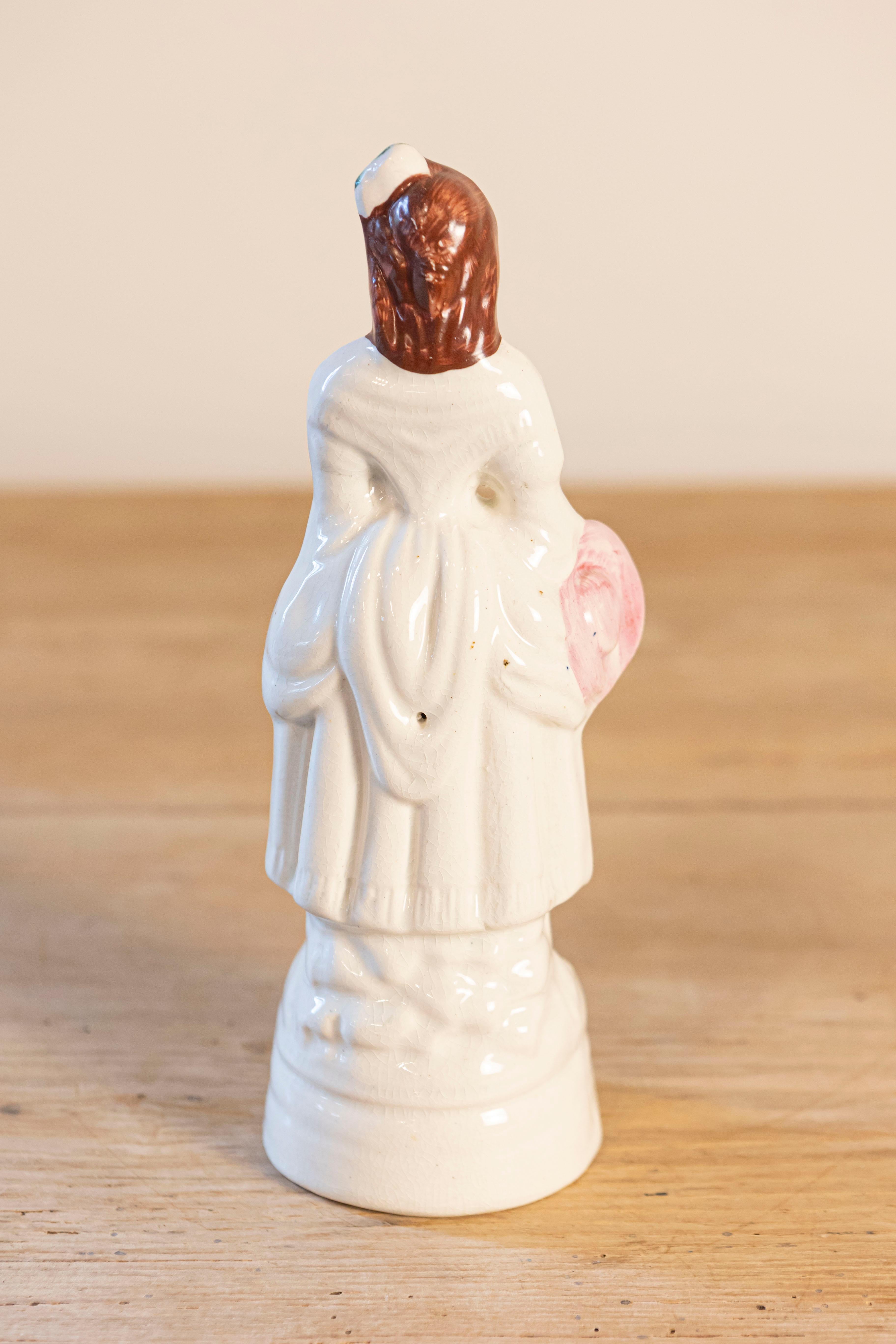Petite English Porcelain Decorative Object Depicting a Lady with a Floral Basket In Good Condition For Sale In Atlanta, GA