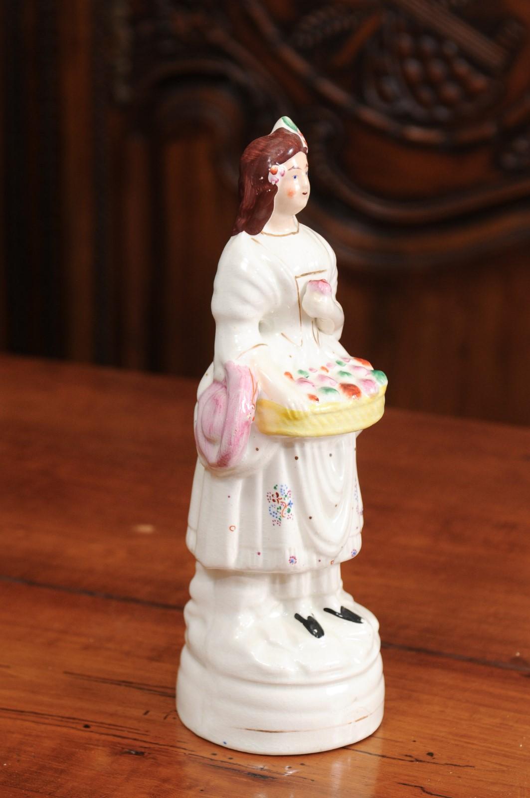 Painted Petite English Porcelain Decorative Object Depicting a Lady with a Floral Basket For Sale