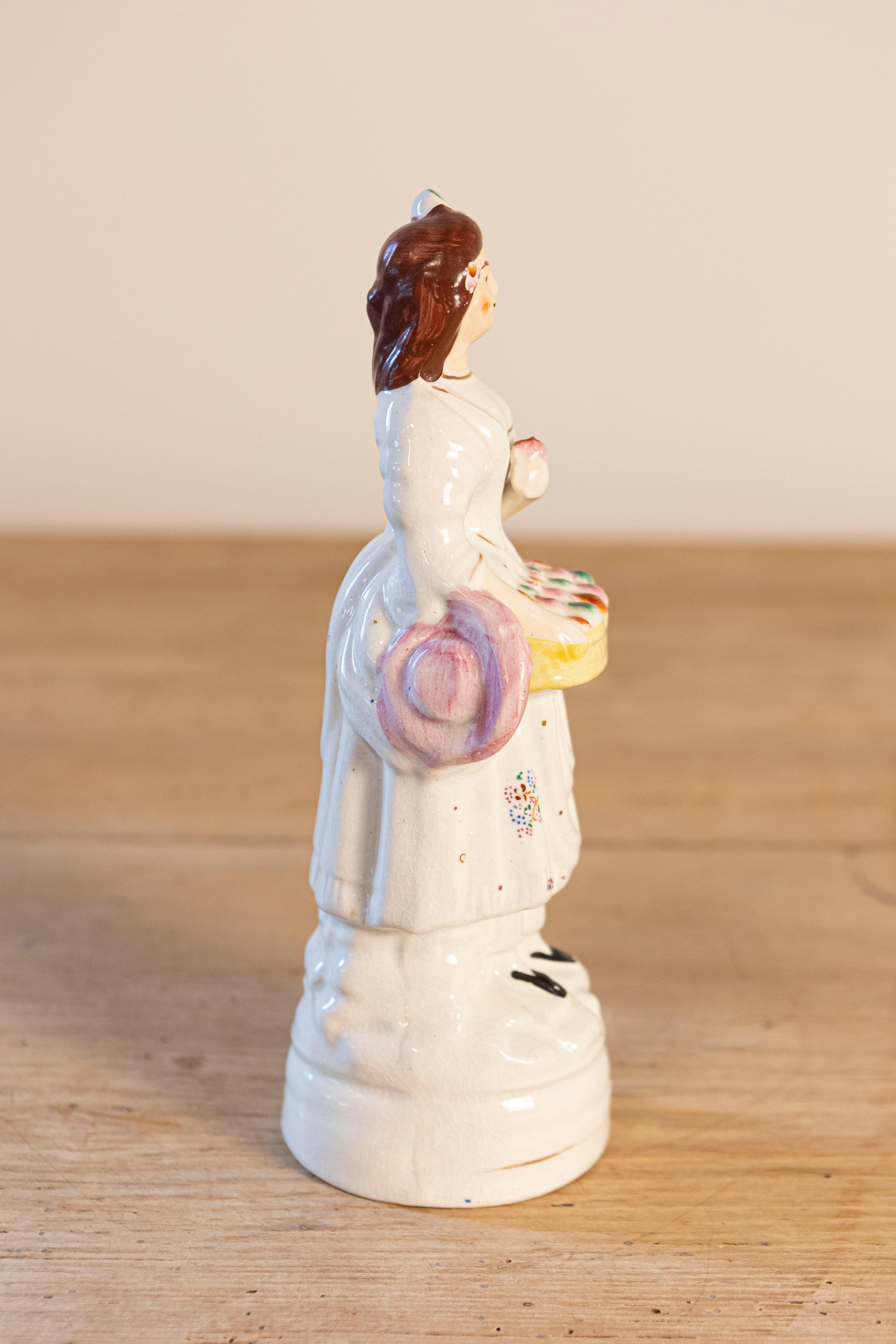 20th Century Petite English Porcelain Decorative Object Depicting a Lady with a Floral Basket For Sale