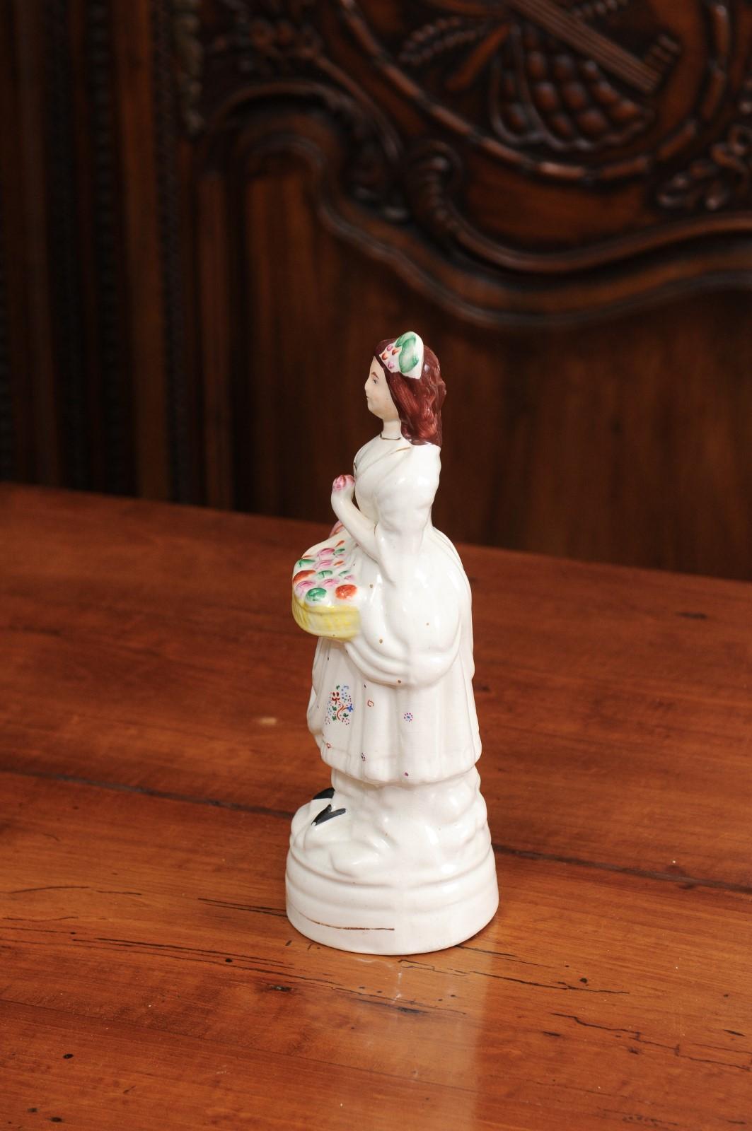 Petite English Porcelain Decorative Object Depicting a Lady with a Floral Basket For Sale 1