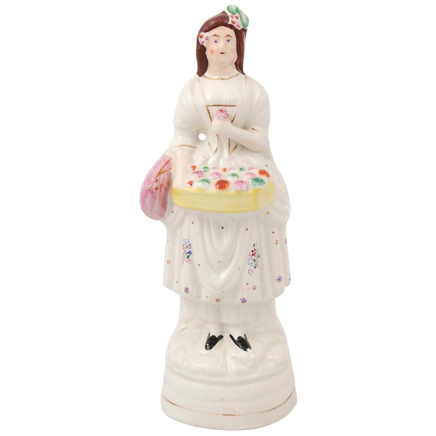 Petite English Porcelain Decorative Object Depicting a Lady with a Floral Basket For Sale