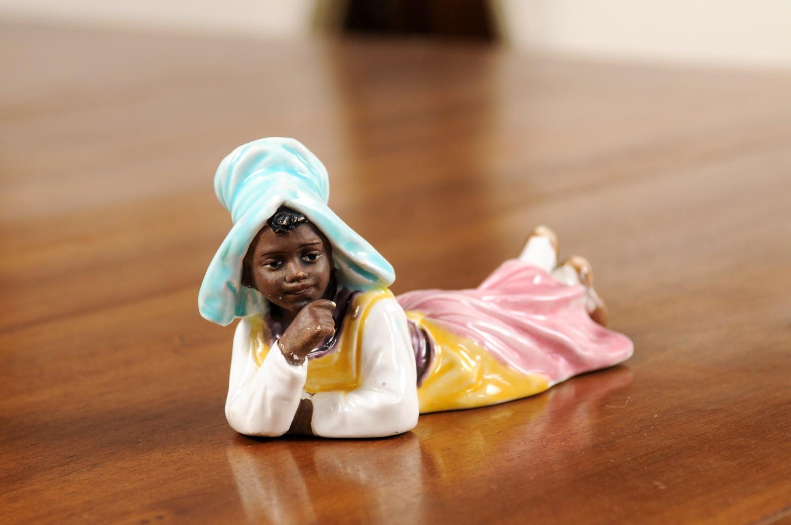 Petite English Porcelain Figurine Depicting a Young Girl Laying on the Ground In Good Condition For Sale In Atlanta, GA