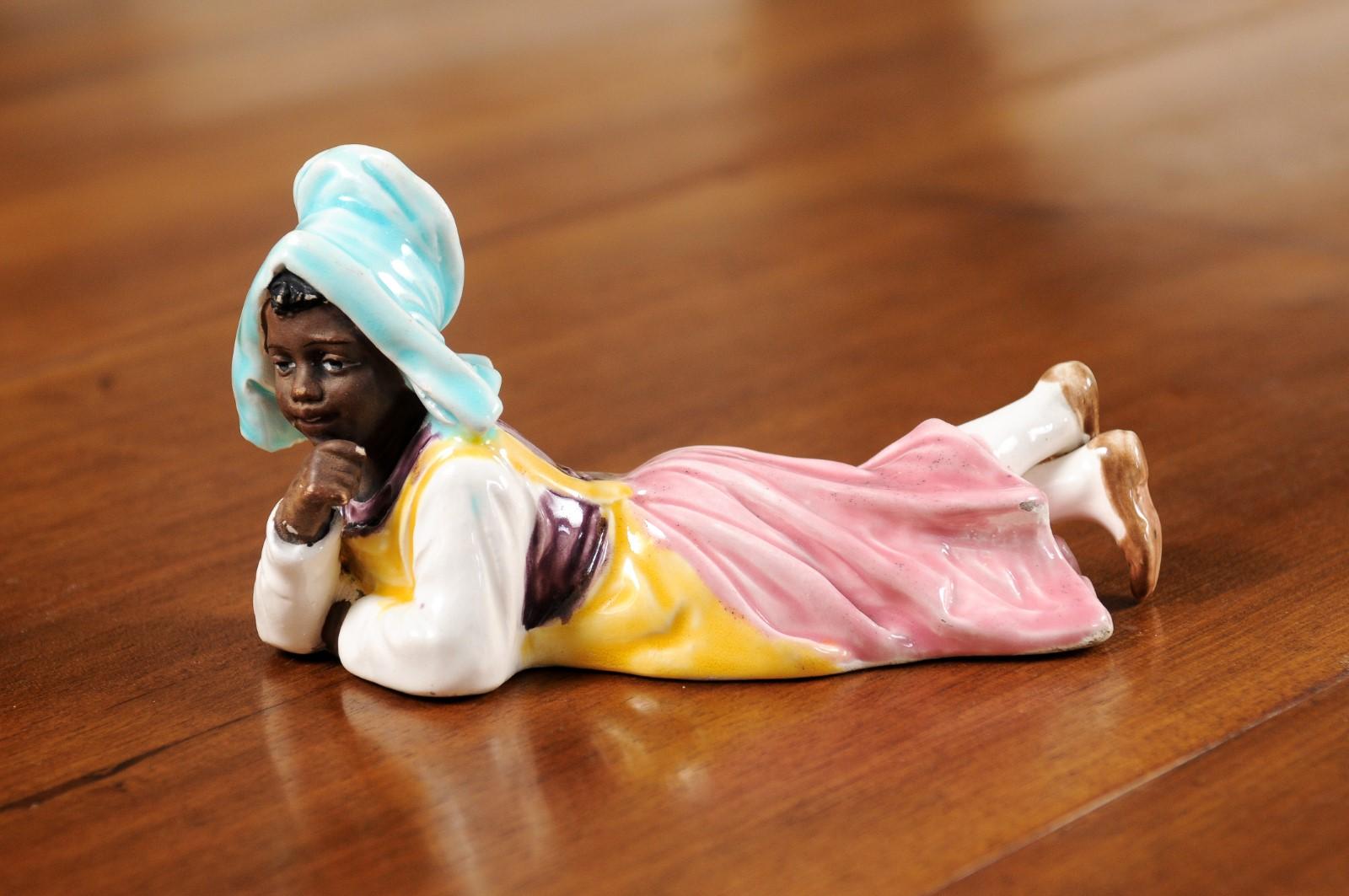 20th Century Petite English Porcelain Figurine Depicting a Young Girl Laying on the Ground For Sale