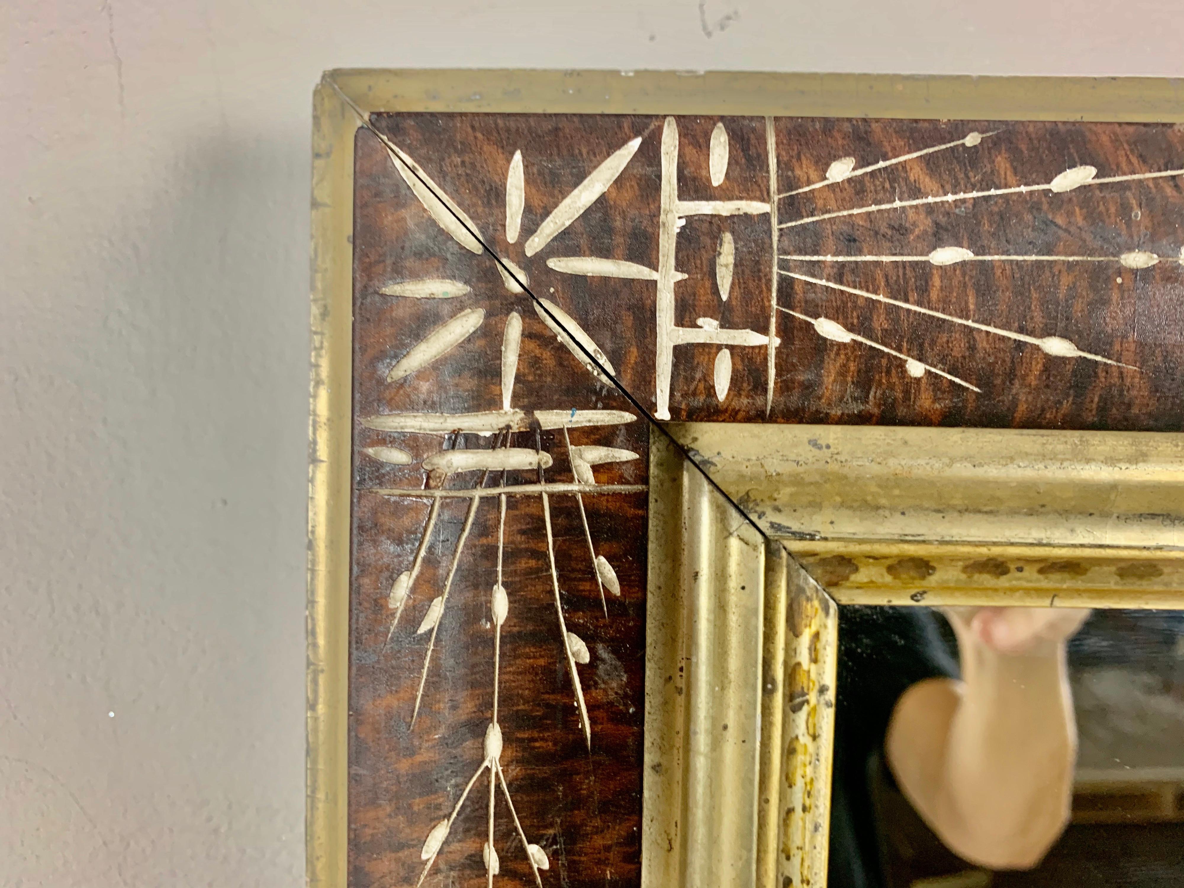 19th century English wood frame with mirror inset. The mirror is decorated with beautiful inlay designs throughout. Giltwood liner with stenciled detailing.