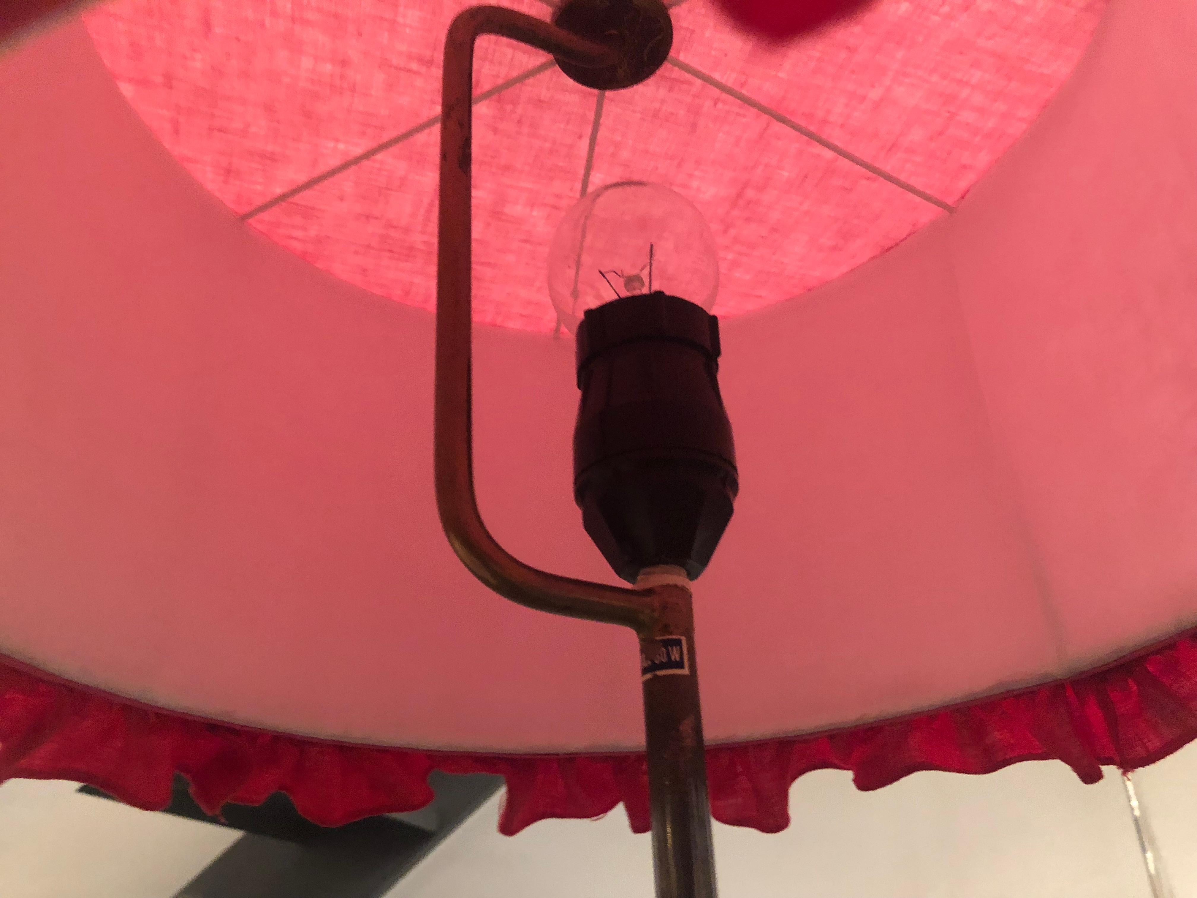 A rare Petit Swedish floor lamp by Hans-Agne Jakobsson
A cone shaped base holds a brass stem ending with a ring finial. Labeled under the base. 
Shade included.