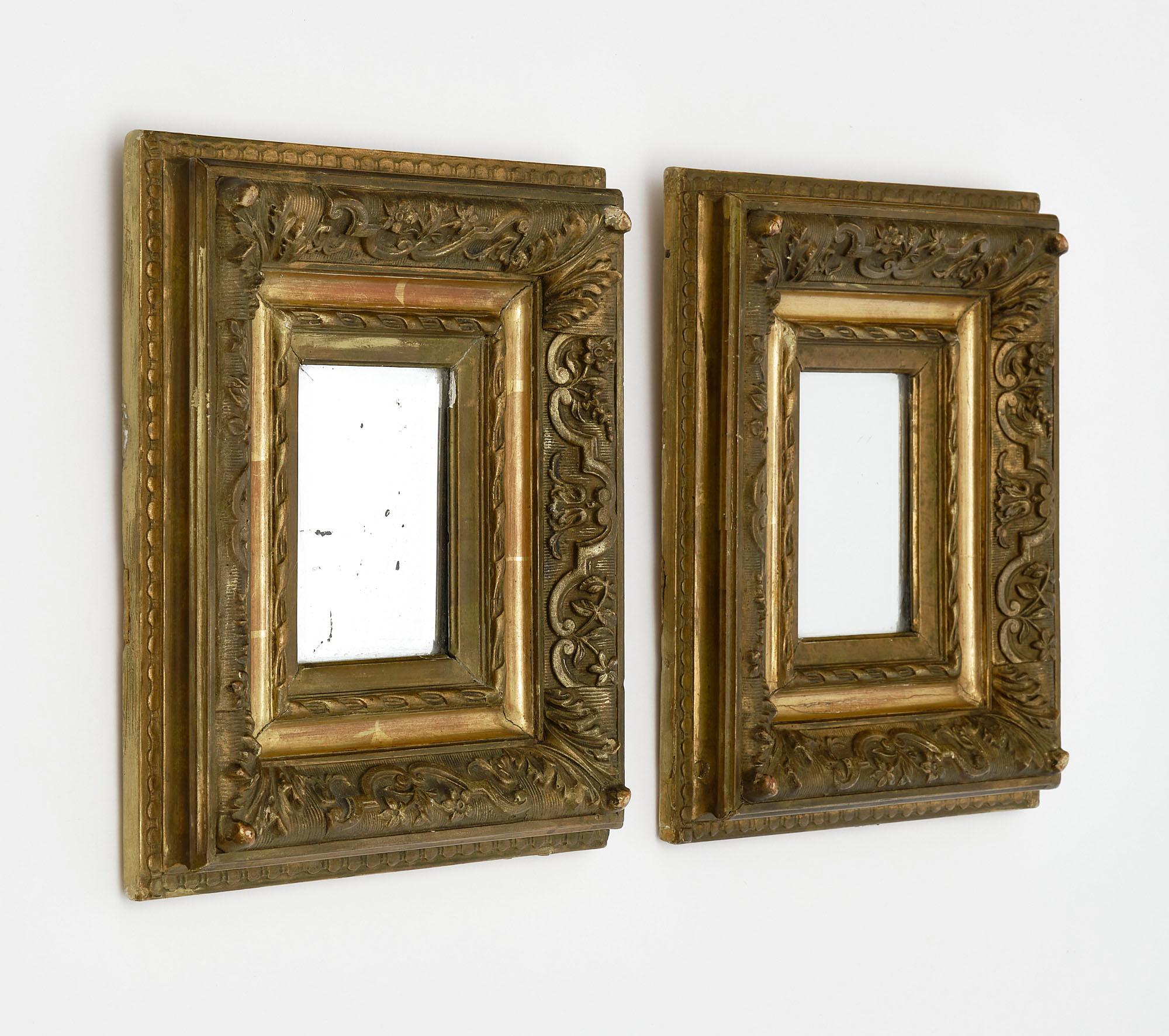 Pair of mirrors from France with hand-carved wooden frames and original 23 carat gold leafing. The interior mercury mirrors and beautiful patina are all original. The mirrors are beveled as well. We love the delicate size and striking French