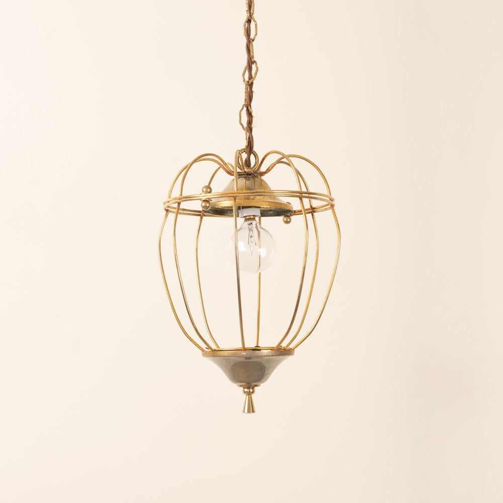 Lovely petite brass lantern pendant light from France, 1950s. Brass lantern with thin curved open frame and brass ball detail. Original finish and chain show nice age and patina. Newly rewired with new brass canopy. Takes one E12 base bulb, 40 W or