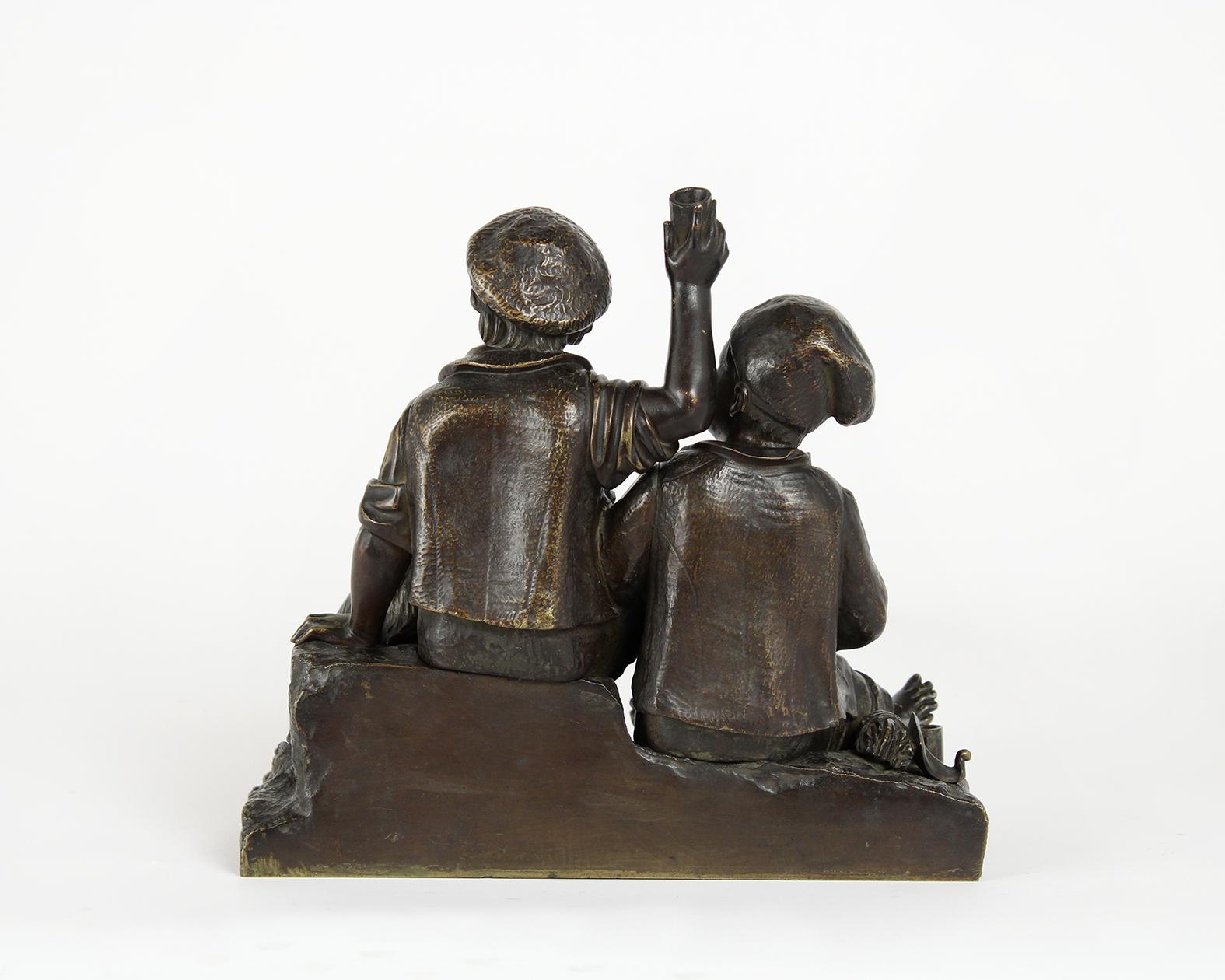 This beautiful French mid-19th century bronze statue figurine has very fine details that have been waxed and polished giving it a beautiful patina finish. This small statue depicting two beggars eating and drinking while sitting on rocks with their