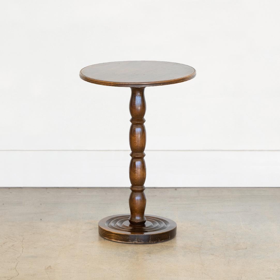 Lovely vintage wood side table from France, 1940's. Circular top with ornate carved wood stem and circular base. Original dark wood stain with some signs of wear. Perfect in between chairs. 
