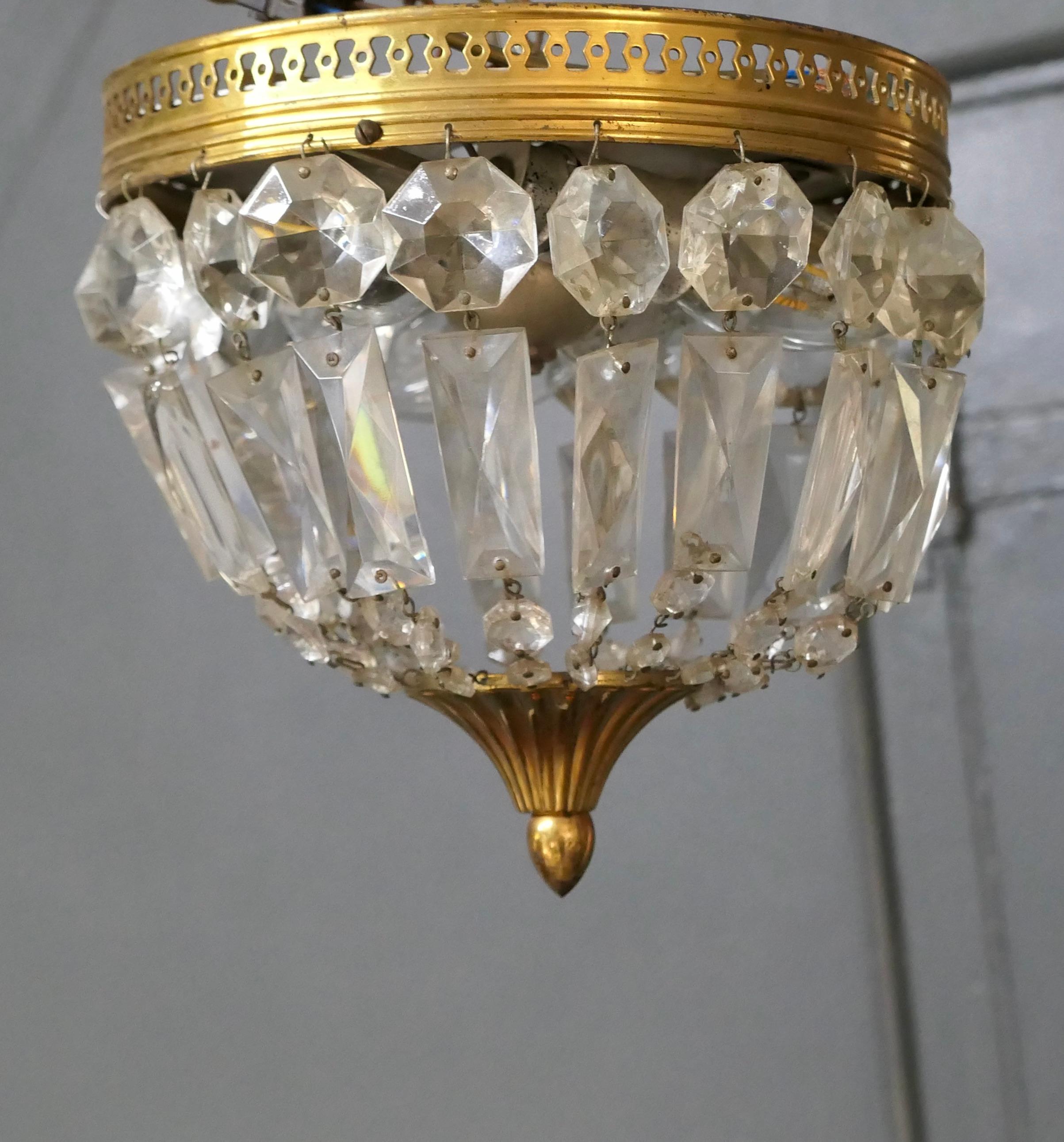 Petite French empire style crystal basket chandelier.

This is a lovely little piece it has a bright brass frame hung with chains forming a basket and a brass roundel forming the base
The Chandelier is in good working condition, it has been