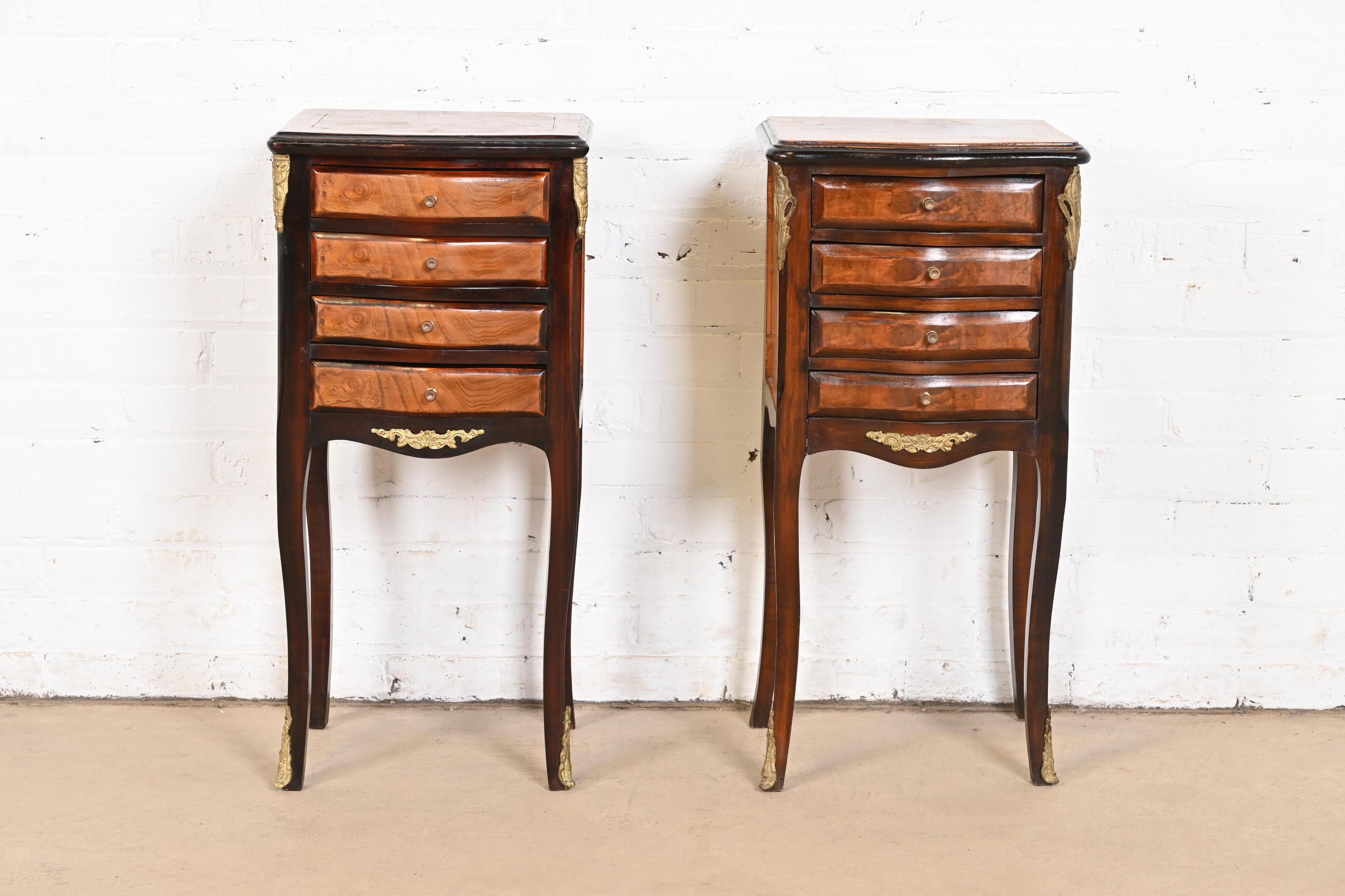 A gorgeous pair of petite French Provincial Louis XV style nightstands or end tables

France, Circa 1940s

Mahogany, with burl wood drawer fronts, satinwood inlay, and brass mounts and hardware.

Each measures: 13.75