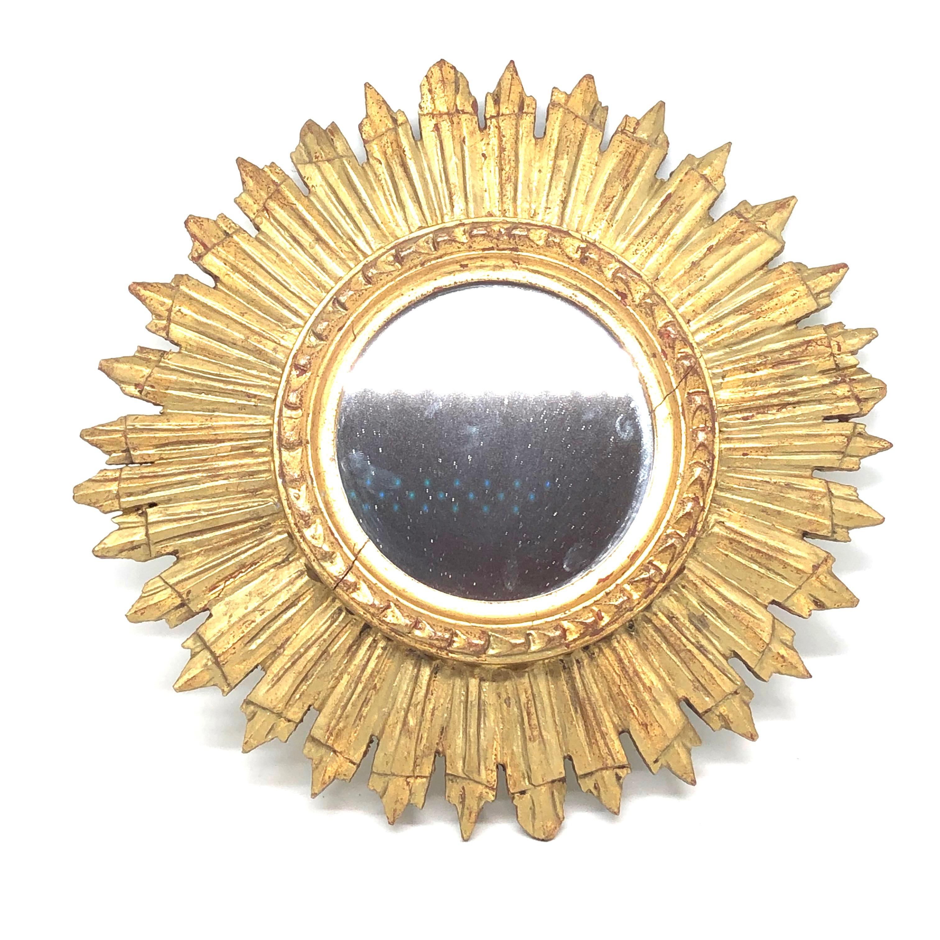 A gorgeous starburst sunburst mirror. Made of gilded wood. It measures approximate 12