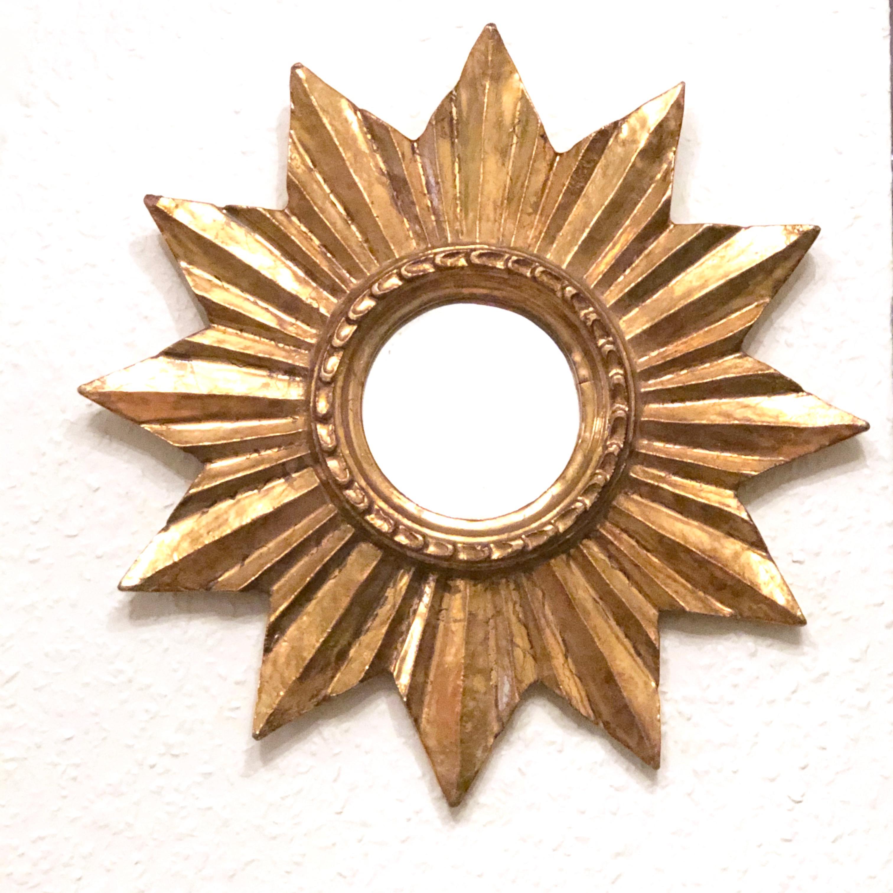 A gorgeous petite starburst mirror. Made of gilded wood. No chips, no cracks, no repairs. It measures approximate 13 1/2