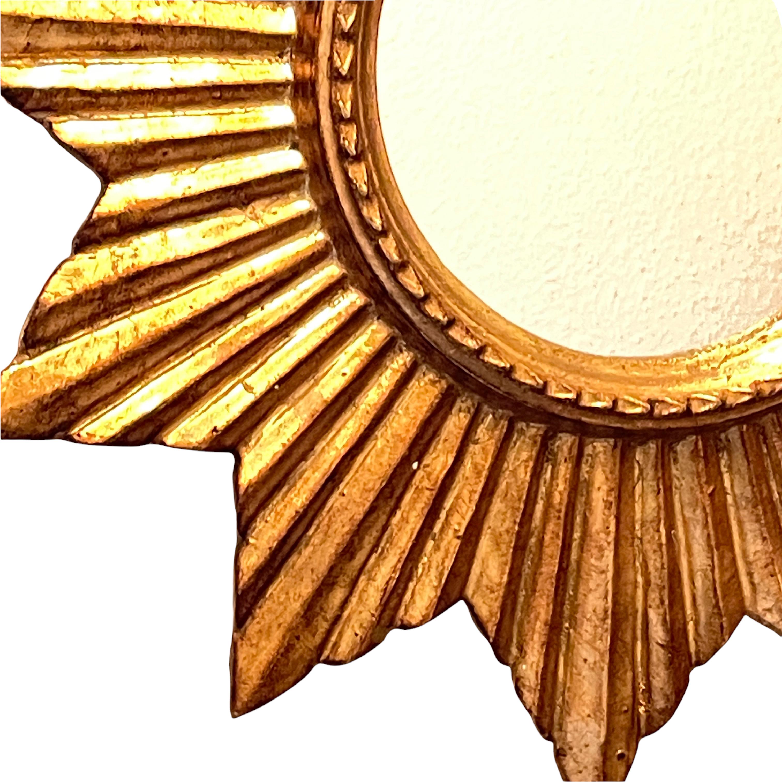 A gorgeous starburst mirror. Made of gilded wood. It measures approximate 19