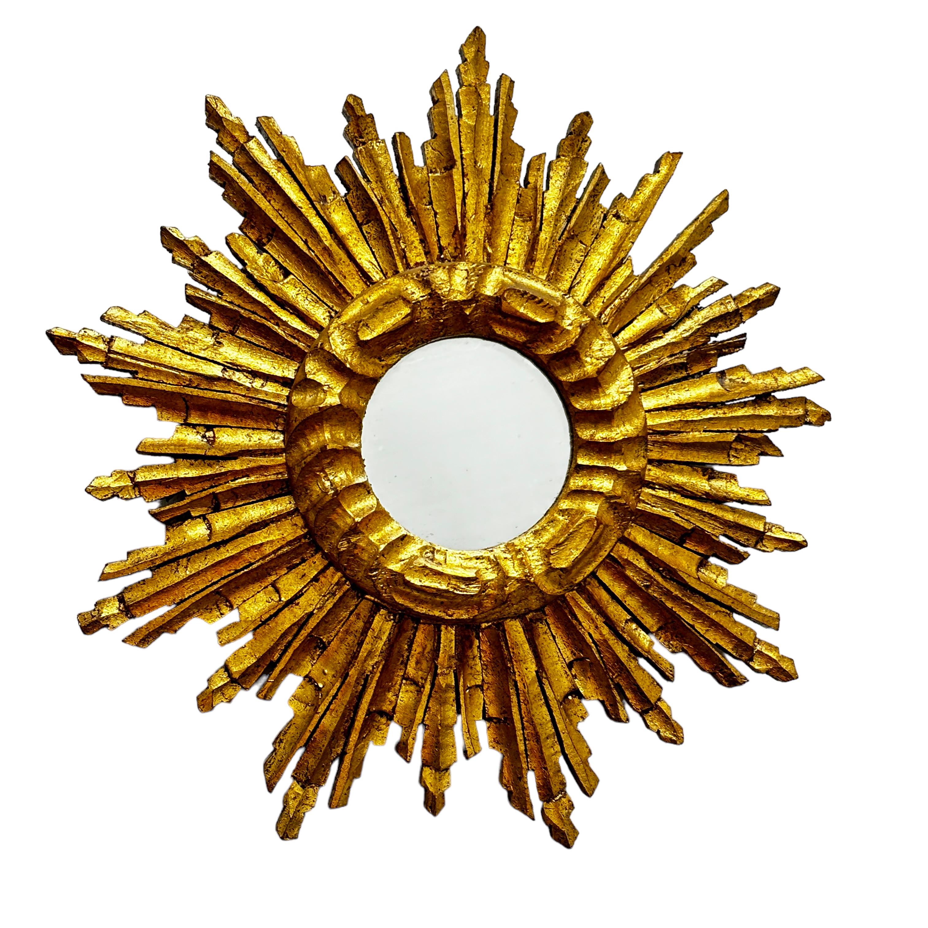 A gorgeous petite starburst mirror. Made of gilded wood. No chips, no cracks, no repairs. It measures approximate: 12.5