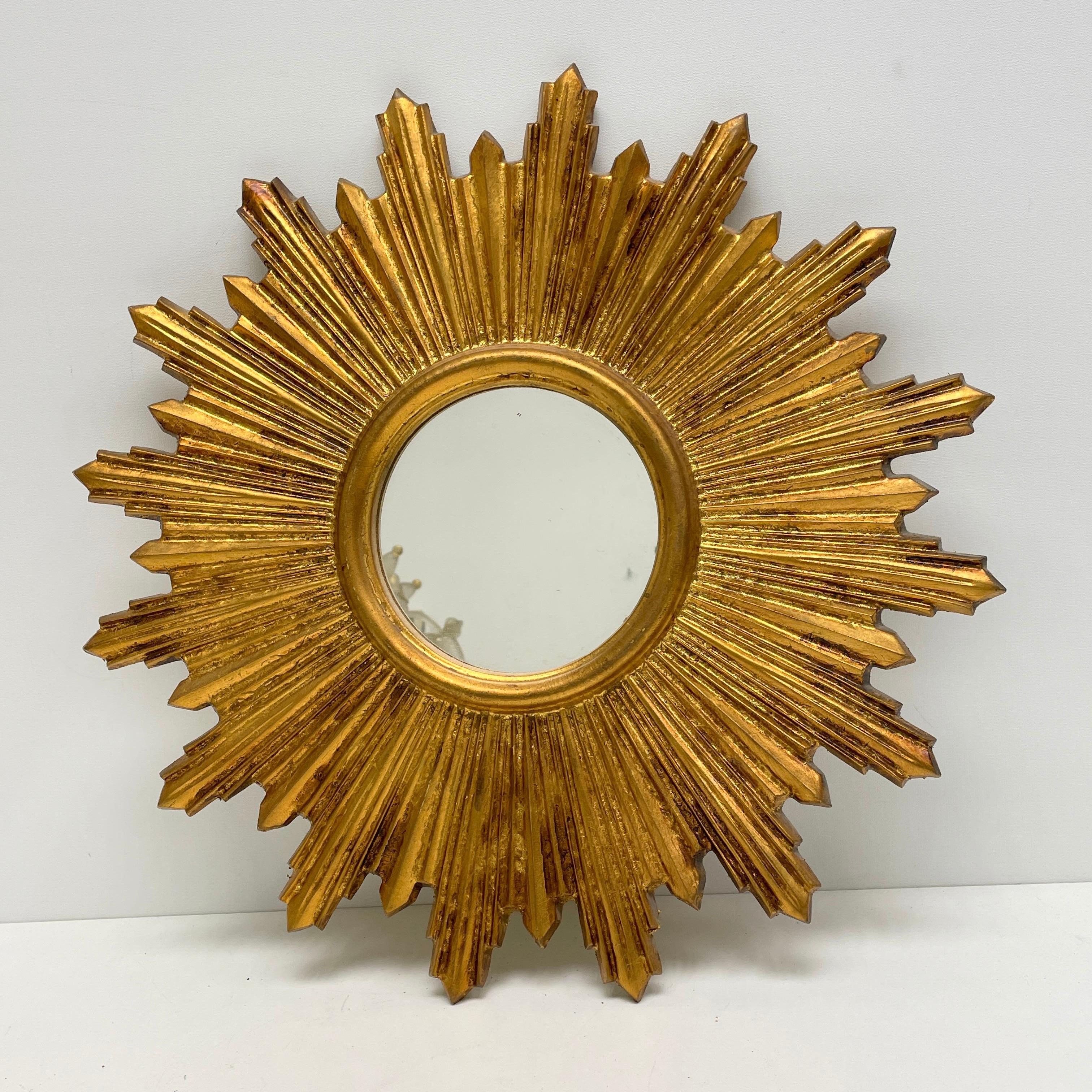 A gorgeous starburst sunburst mirror. Made of gilded wood. It measures approximate: 16 7/8