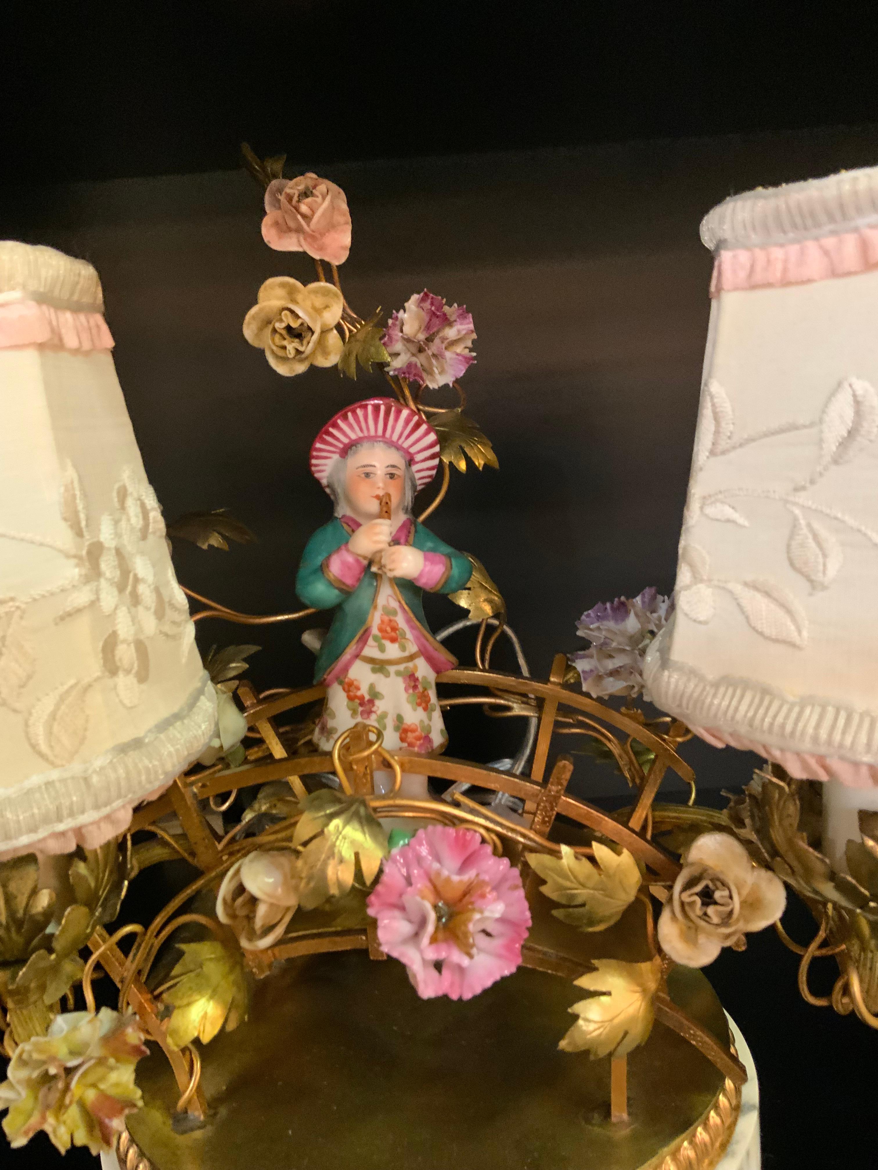 The petite size with porcelain accents makes this
Piece special. It has two lights with custom embroidered 
Sfumature  it sits on a white and gray base
