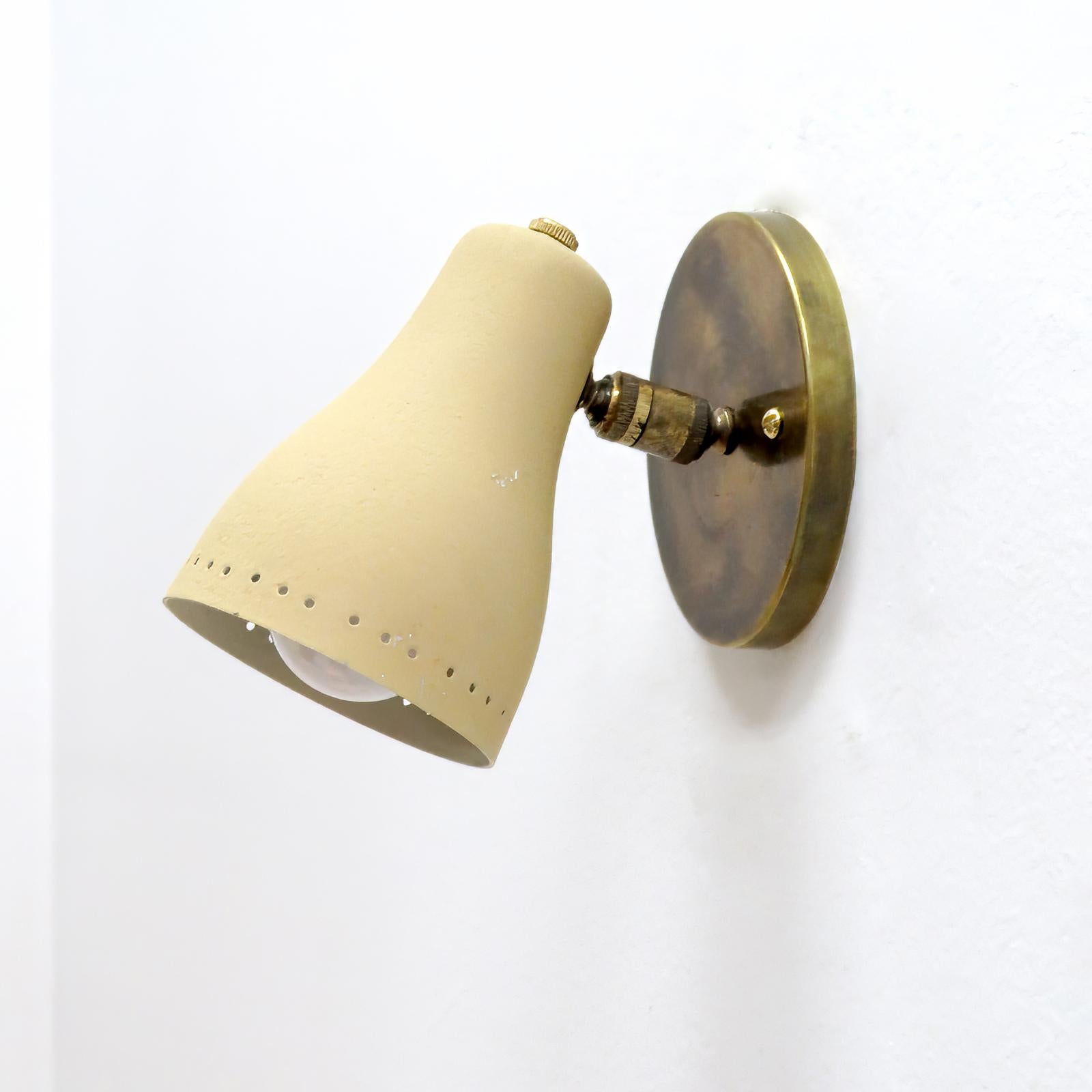 Pair of fabulous French wall lights, 1950, in brass with ivory color, perforated shades, fully adjustable with individual on/off switch, wired for US standards, one E12 socket per light, max. wattage 60w each, bulbs provided as a onetime courtesy.