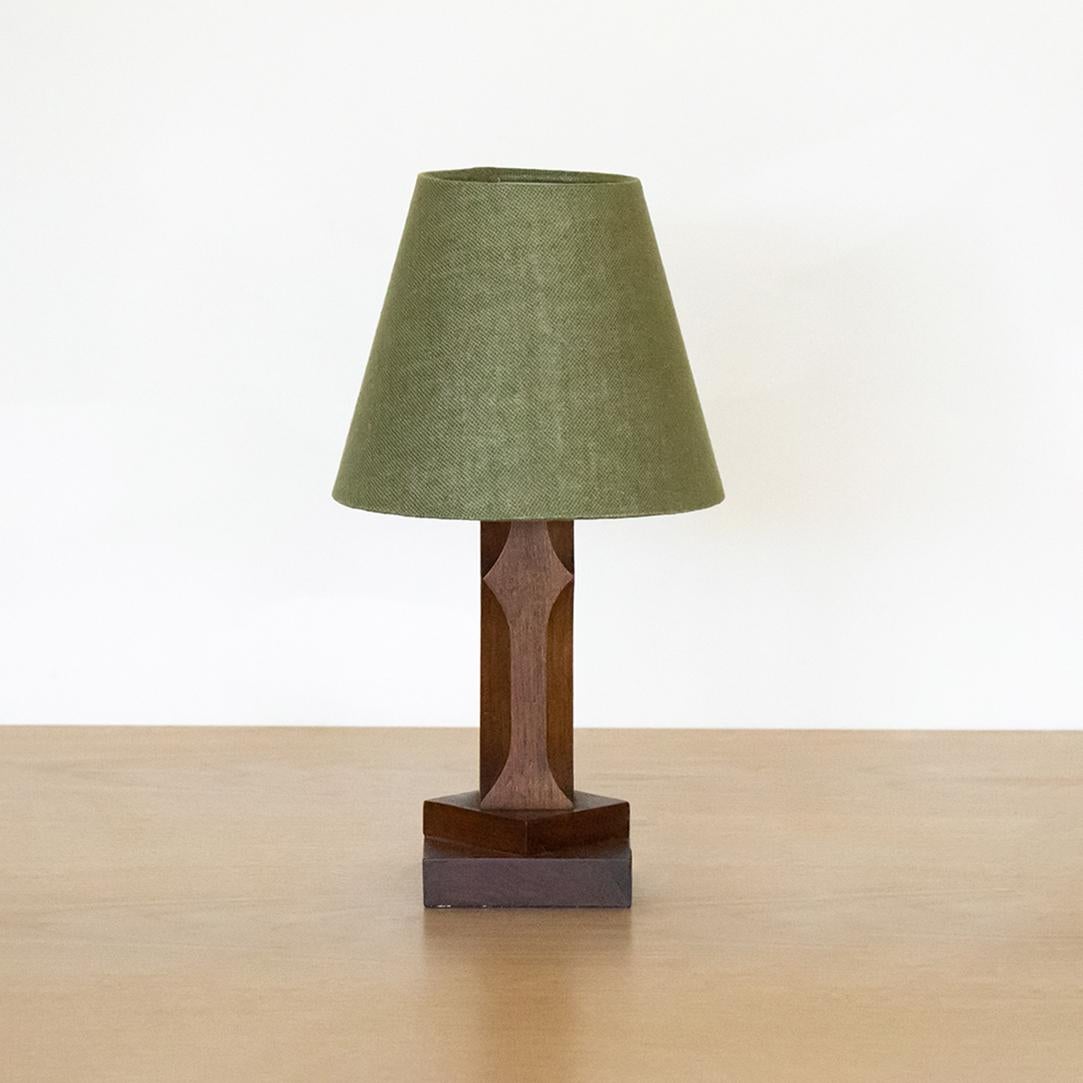 Petite wood table lamp from France, 1940s. Geometric carved wood base with all original wood finish. New green linen shade and newly re-wired. 
  
